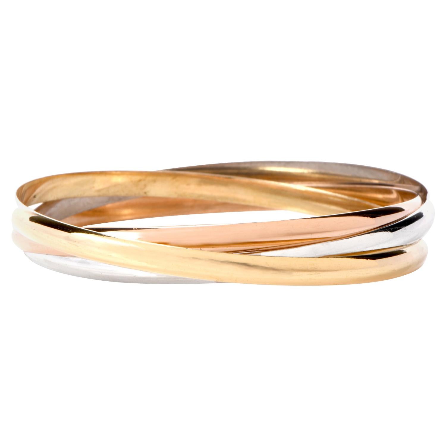 Mix and Match your entire jewelry wardrobe while
wearing and enjoying this beautiful Catier multi-bangle bracelet  made  in 18K rose, yellow, and white gold.

Each interlocking bracelet has been highly polished to accent

the color.

Weighing appx.