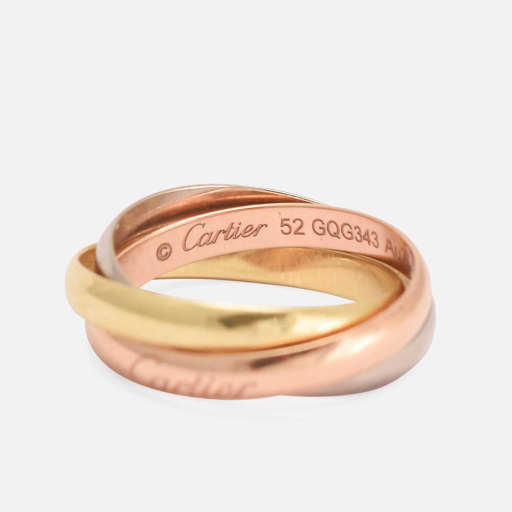 A classic Cartier Russian wedding band. It comprises three 18 karat gold bands (rose, white and yellow), interlinked to create a beautiful symbol of eternal love. It's signed Cartier 750, with the Cartier lettering to the outer rose gold band.

RING