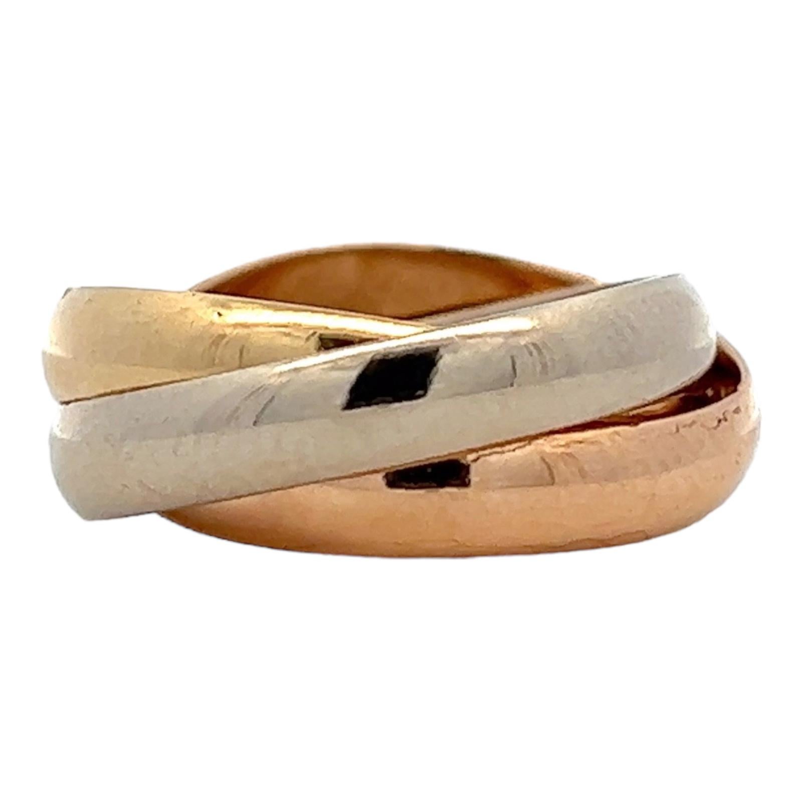 Iconic Cartier Trinity Rolling Ring crafted in 18 karat yellow, white, and rose gold. The ring is size 50 ( US size 5). Signed Cartier, les must de Cartier, numbered, and hallmarked. 