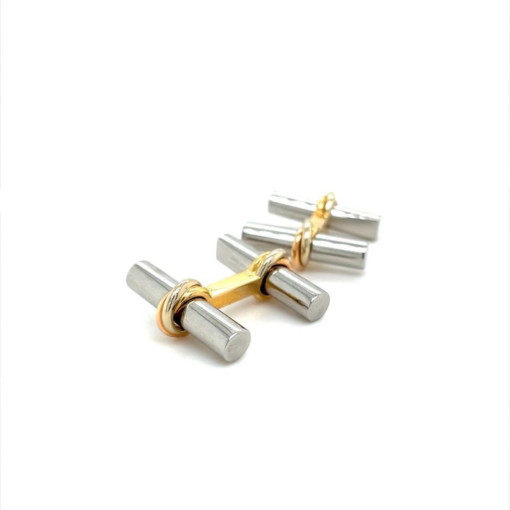A pair of Cartier Trinity 18 karat yellow gold and steel T-Bar cufflinks.

These smart vintage cufflinks feature two steel batons detailed with a plain polished finish between 18 karat yellow gold T-bar fittings each featuring the iconic intertwined