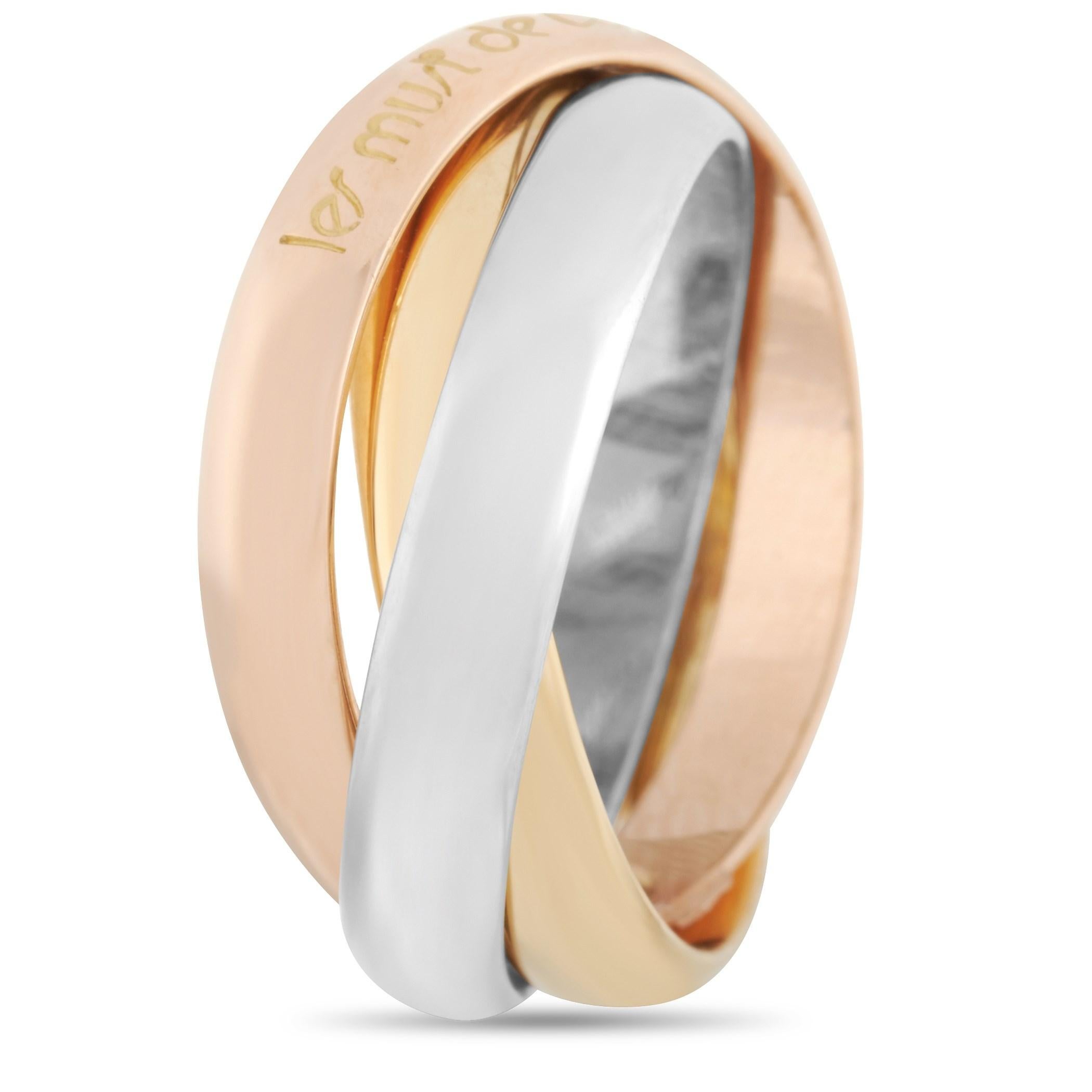 This Cartier “Trinity” ring is crafted with 18K yellow, rose and white gold and weighs 7.9 grams. The ring boasts a band thickness of 8 mm and features an engraved text on the ring 