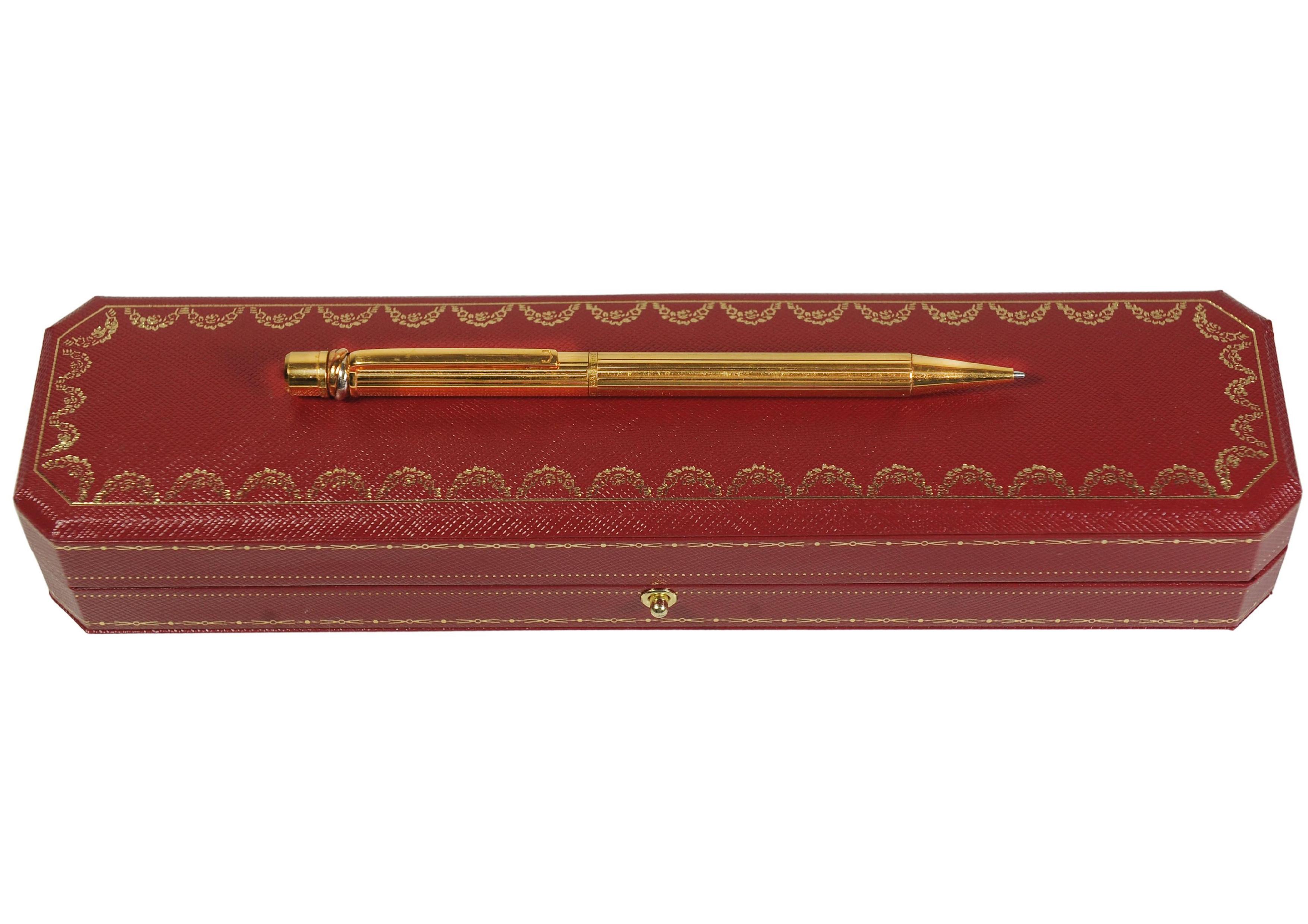 Cartier Trinity 18ct Gold Plated Ribbed Ballpoint Pen With A Red Cartier Box For Sale 1