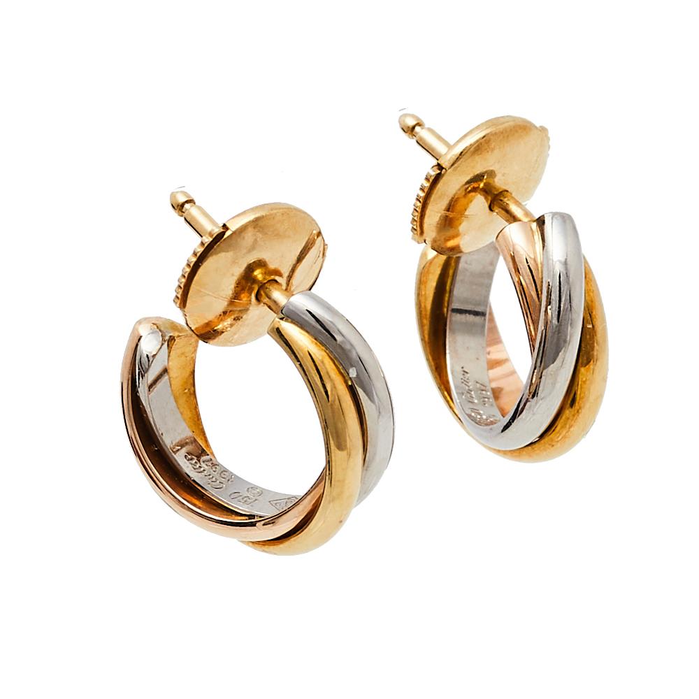 Delivering on the idea of timeless everyday-wear jewelry, Cartier brings you this set of Trinity earrings. Designed in an open hoop shape, these Cartier earrings feature an elegantly curved structure that beautifully wraps around your lobe. They are