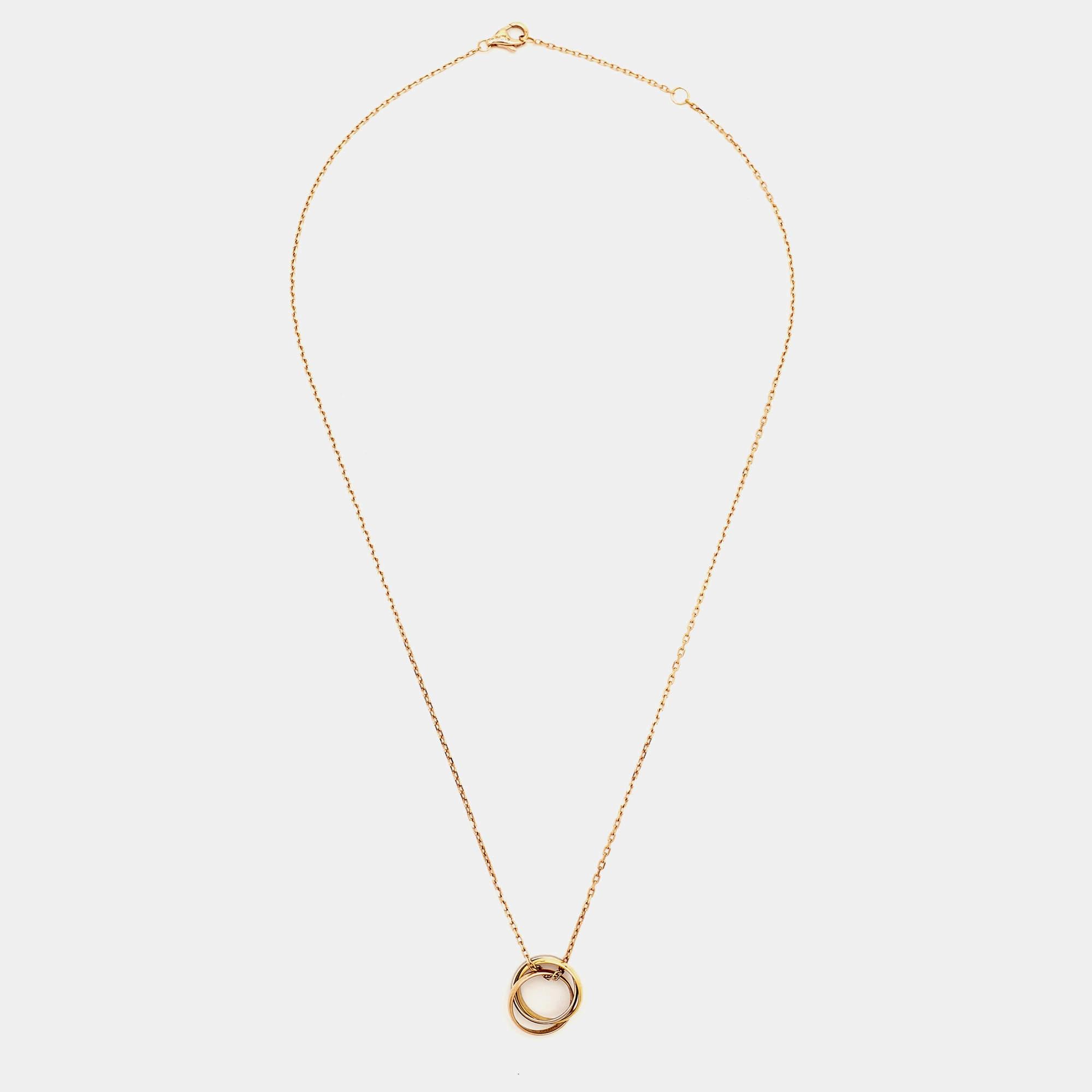 The Cartier necklace is a luxurious piece of jewelry featuring three intertwined rings made of 18k white, yellow, and rose gold. This iconic design symbolizes love, fidelity, and friendship, creating an elegant and timeless accessory.

