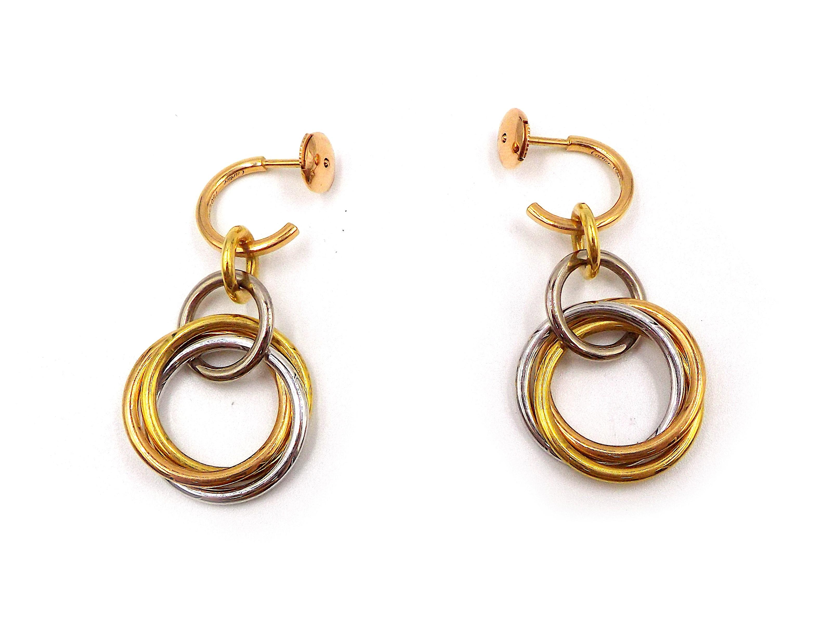 A pair of stylish tri-color gold and diamond earrings by Cartier. Each earring weighs 8.5g, dimensions 1.75