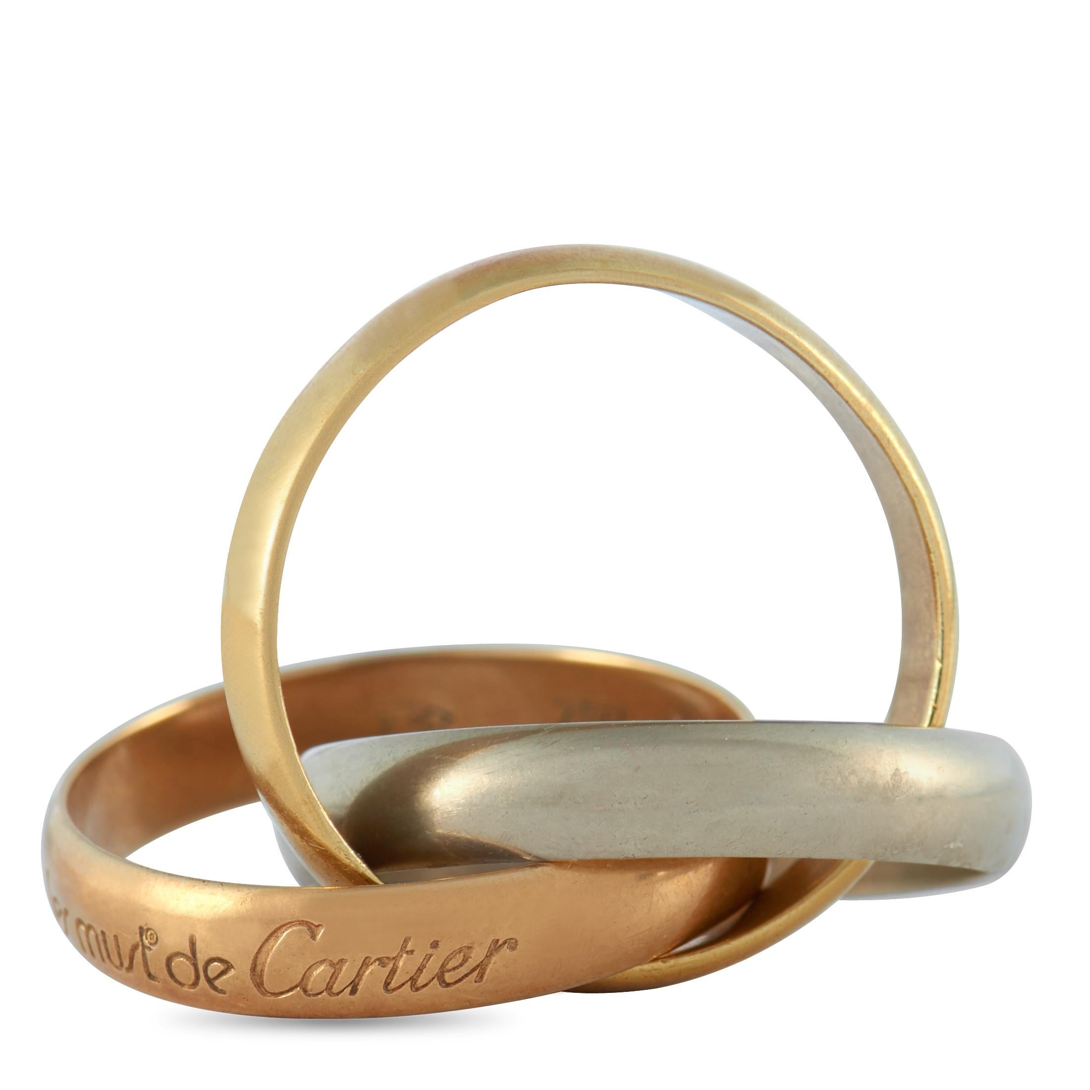 The Cartier “Trinity” ring is made out of 18K white, yellow and rose gold and weighs 7.3 grams, boasting band thickness of 8 mm.
 
 This jewelry piece is offered in estate condition and includes the manufacturer’s box.
