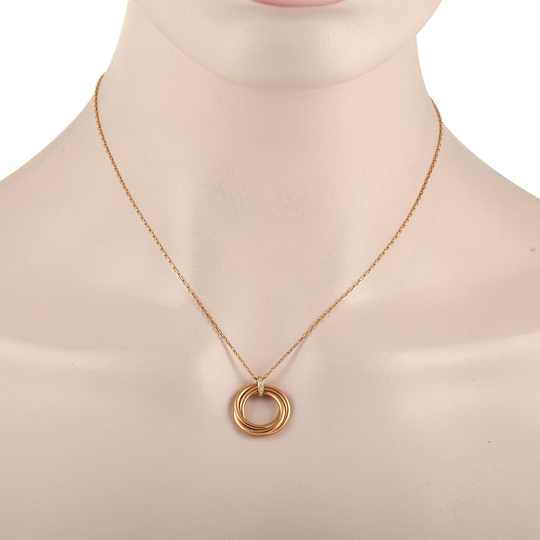 This stylish, simplistic Cartier Trinity pendant necklace is a celebration of the storied brand’s understated elegance. Suspended from a 16” chain is a .75” circular pendant that is comprised of three intertwined 18K Yellow Gold bands. Sparkling