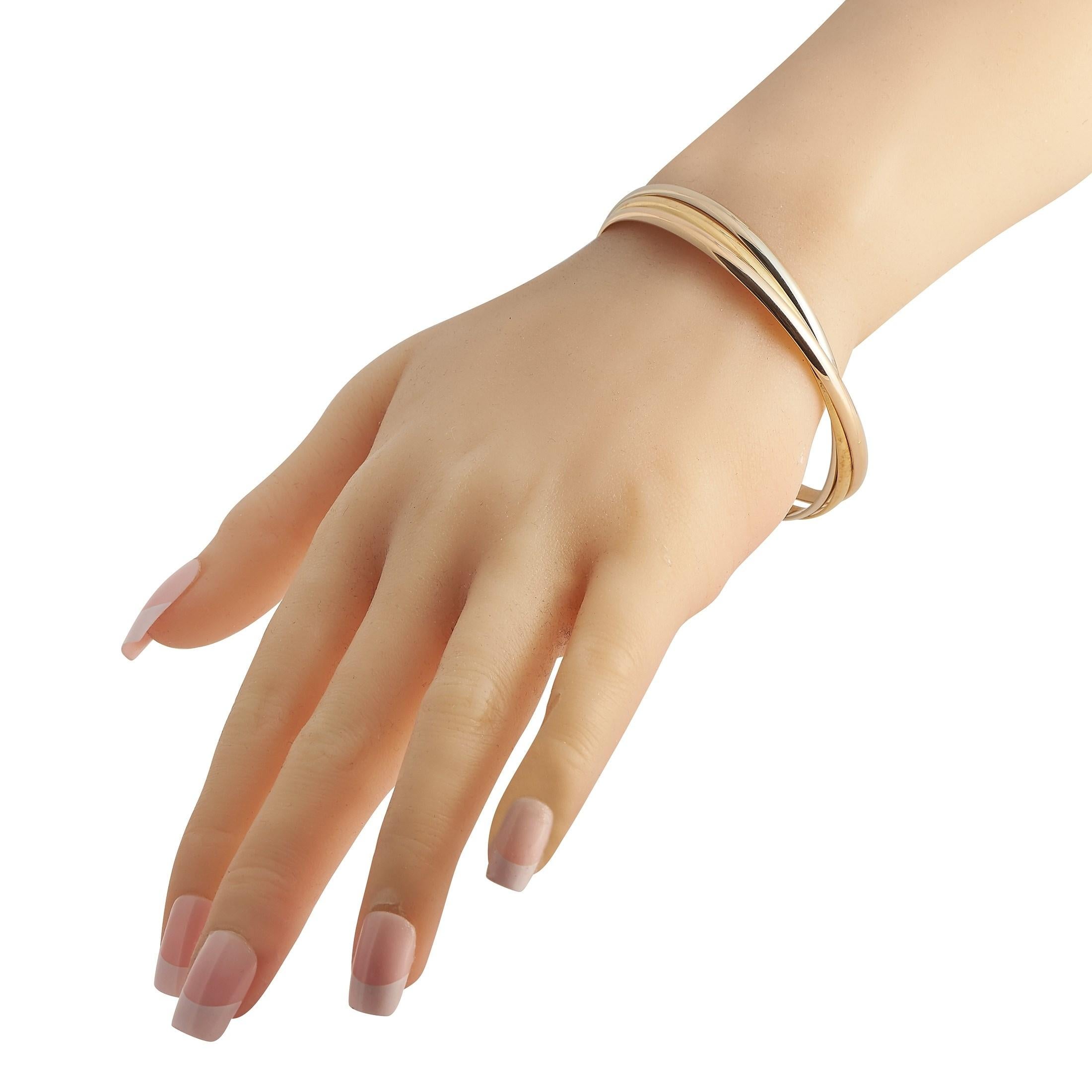 With restrained elegance and symbolic meaning, there's no reason why you wouldn't want to add this Cartier bangle bracelet to your jewelry collection. Called a Trinity Bracelet, this piece features rose gold, white gold, and yellow gold rings