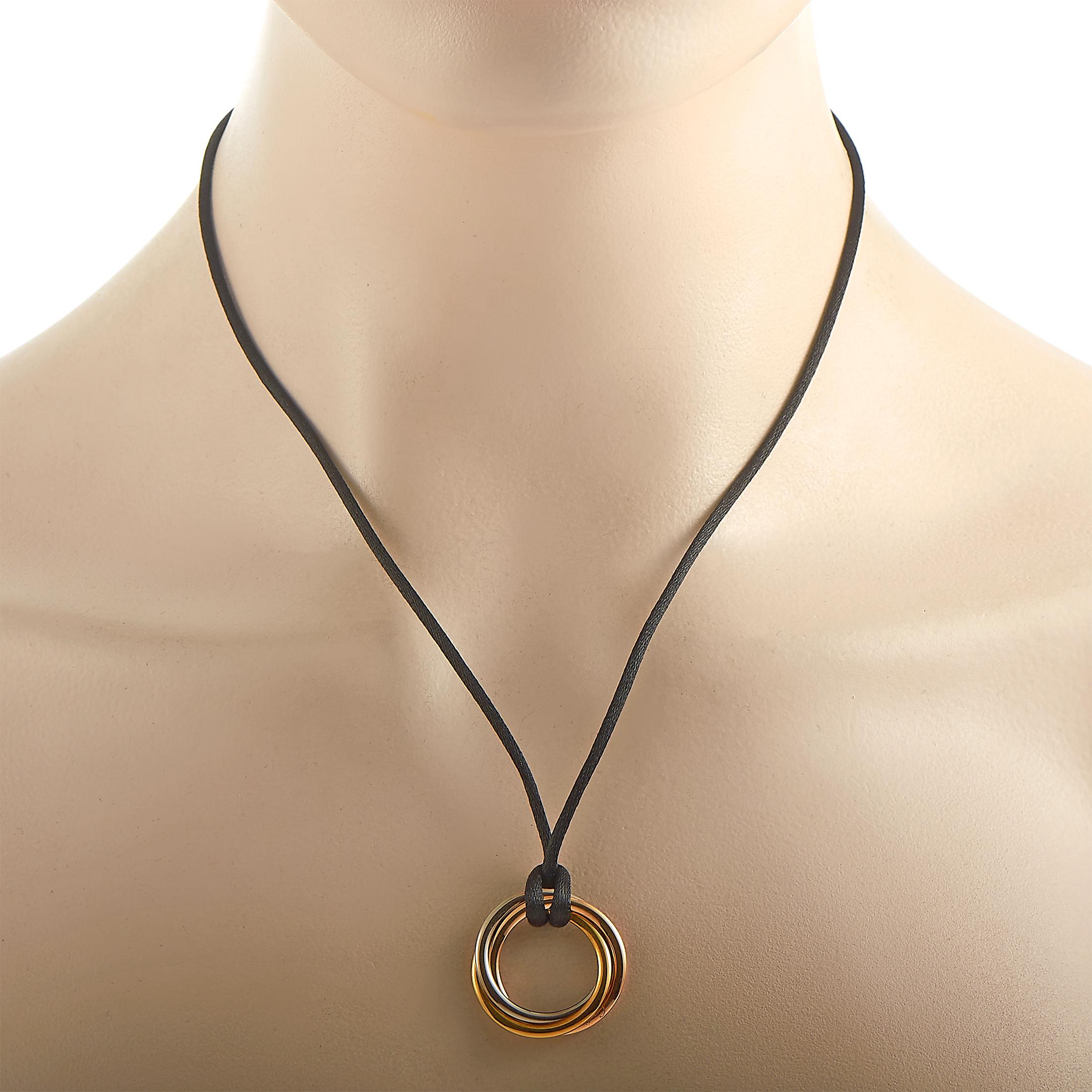 The Cartier “Trinity” necklace is presented with a 22” black cord onto which a 1” by 1” pendant is attached, made out of 18K yellow, white and rose gold.
Retail Price: $2220

This jewelry piece is offered in estate condition and includes the