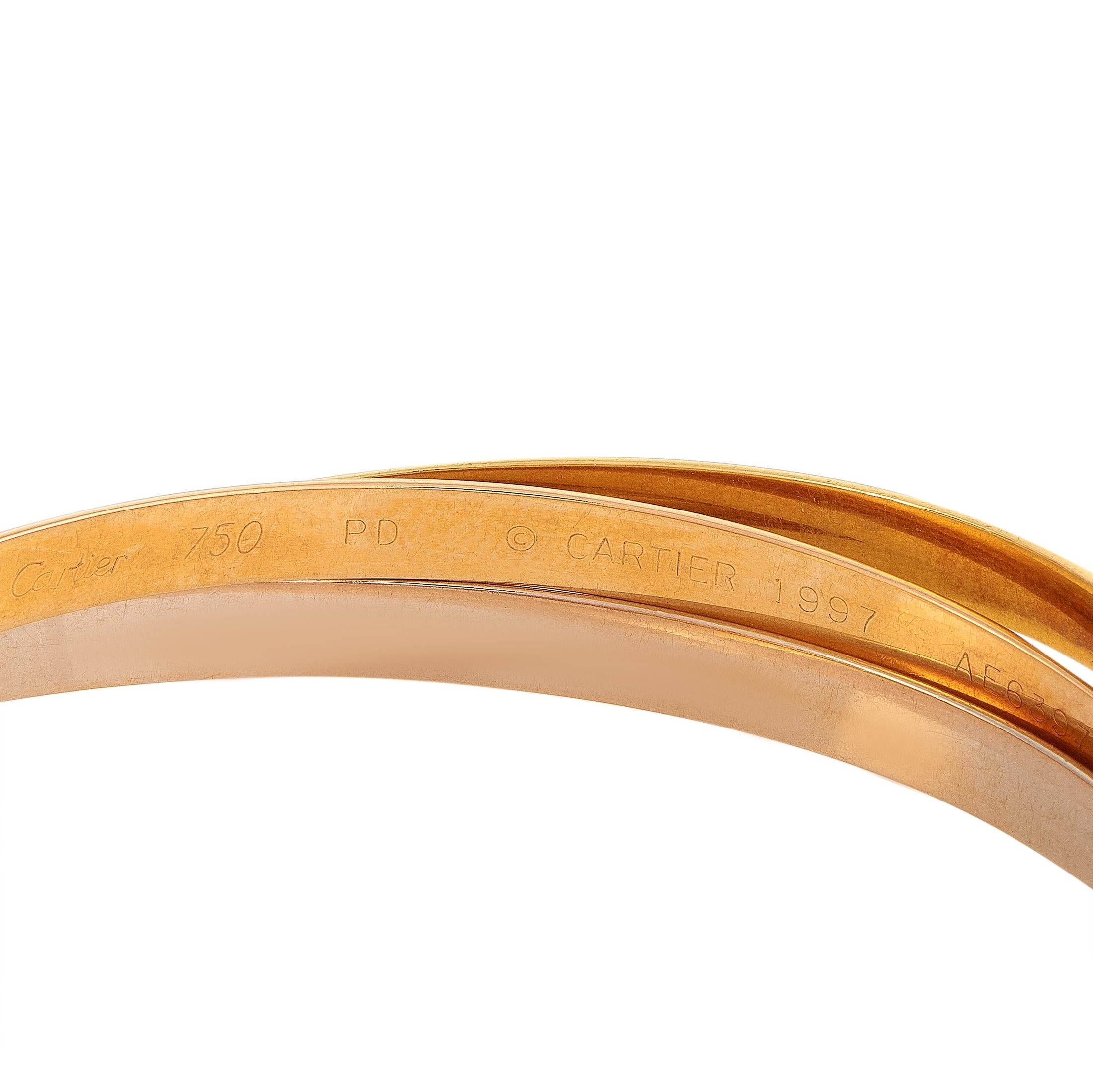 Cartier Trinity 18 Karat Yellow, White and Rose Gold Rolling Bangle Bracelet In Excellent Condition In Southampton, PA