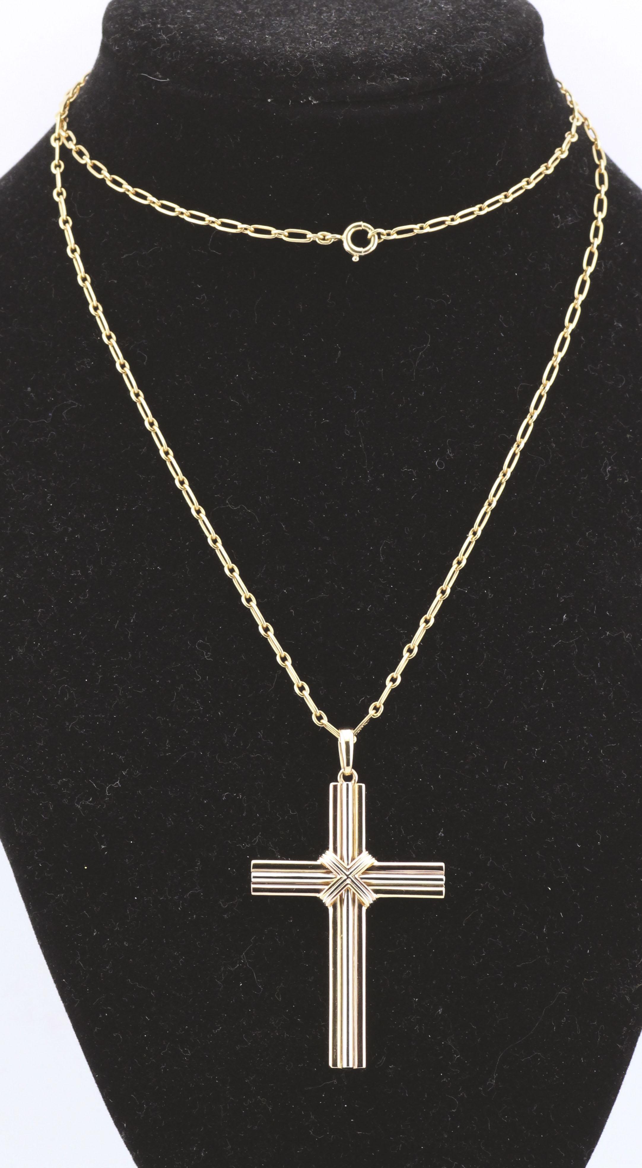 The Cartier Trinity 18K Yellow, White & Pink Gold Cross Pendant Long Necklace is a stunning embodiment of the Maison’s iconic design philosophy, seamlessly blending timeless elegance with symbolic meaning.

Crafted from 18K yellow, white, and pink