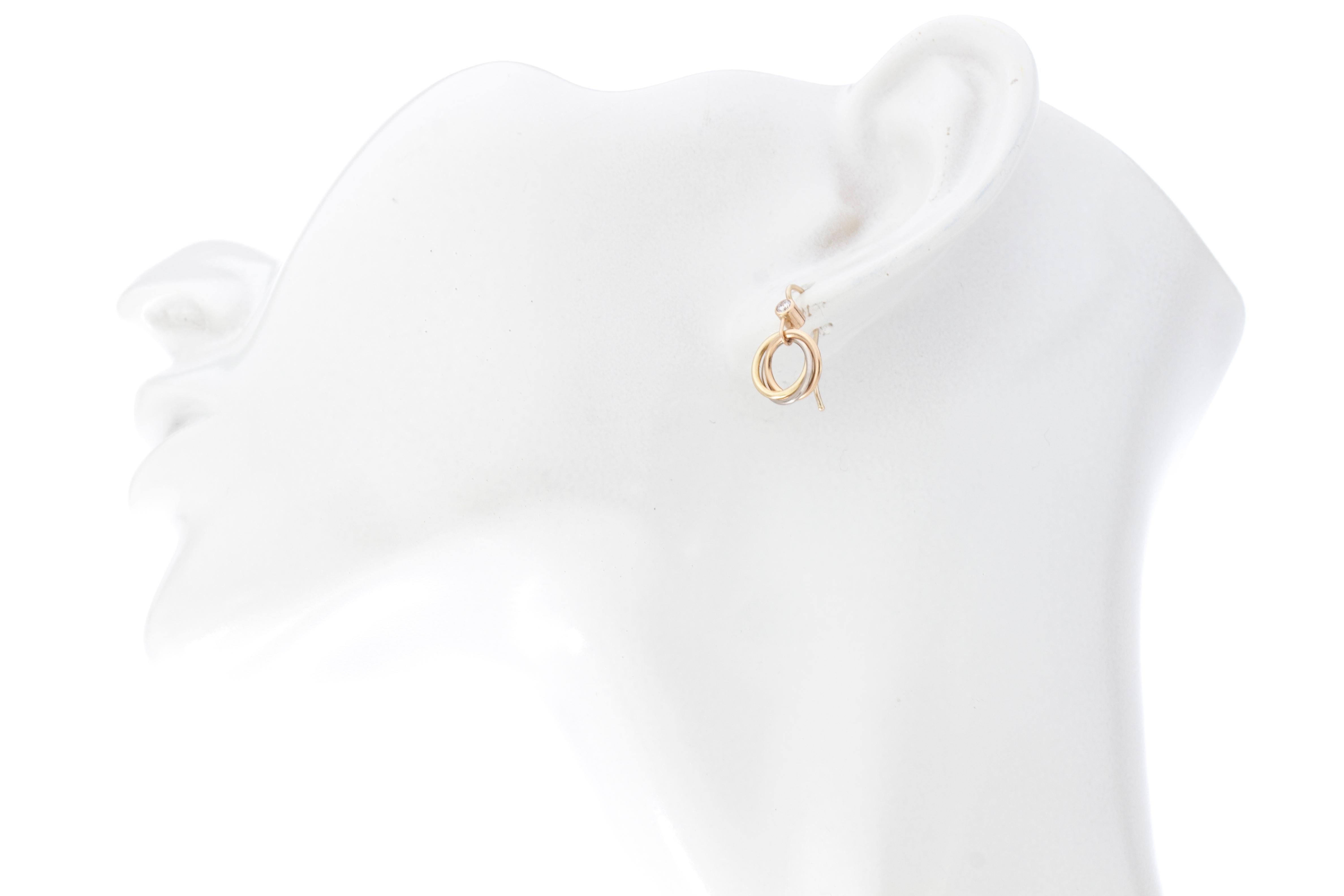 Cartier trinity 18kt white yellow and rose gold ladies earrings with diamond
Designer: Cartier
Made in France, Paris circa 1990's
Fully hallmarked.

Dimension - 
Size : 2 x 1.2
Weight : 3 grams

Diamond - 
Cut : Round
Quantity of stones : 2
Sizes :