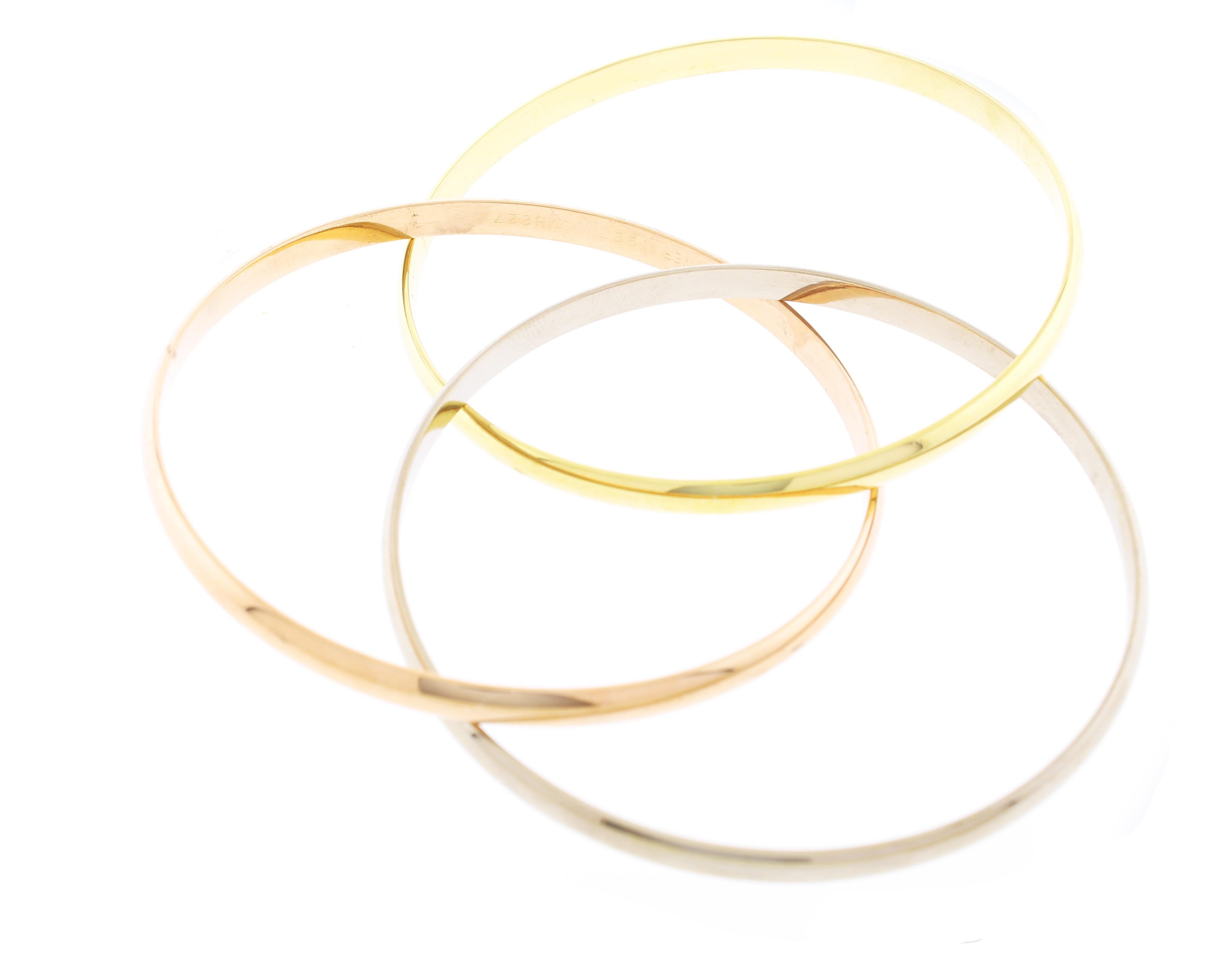 From Cartier, this bracelet is from the trinity collection.   Three interlocking bands, each made from a different color of gold: yellow gold representing fidelity, rose gold representing love, and white gold representing friendship.
♦ Designer: