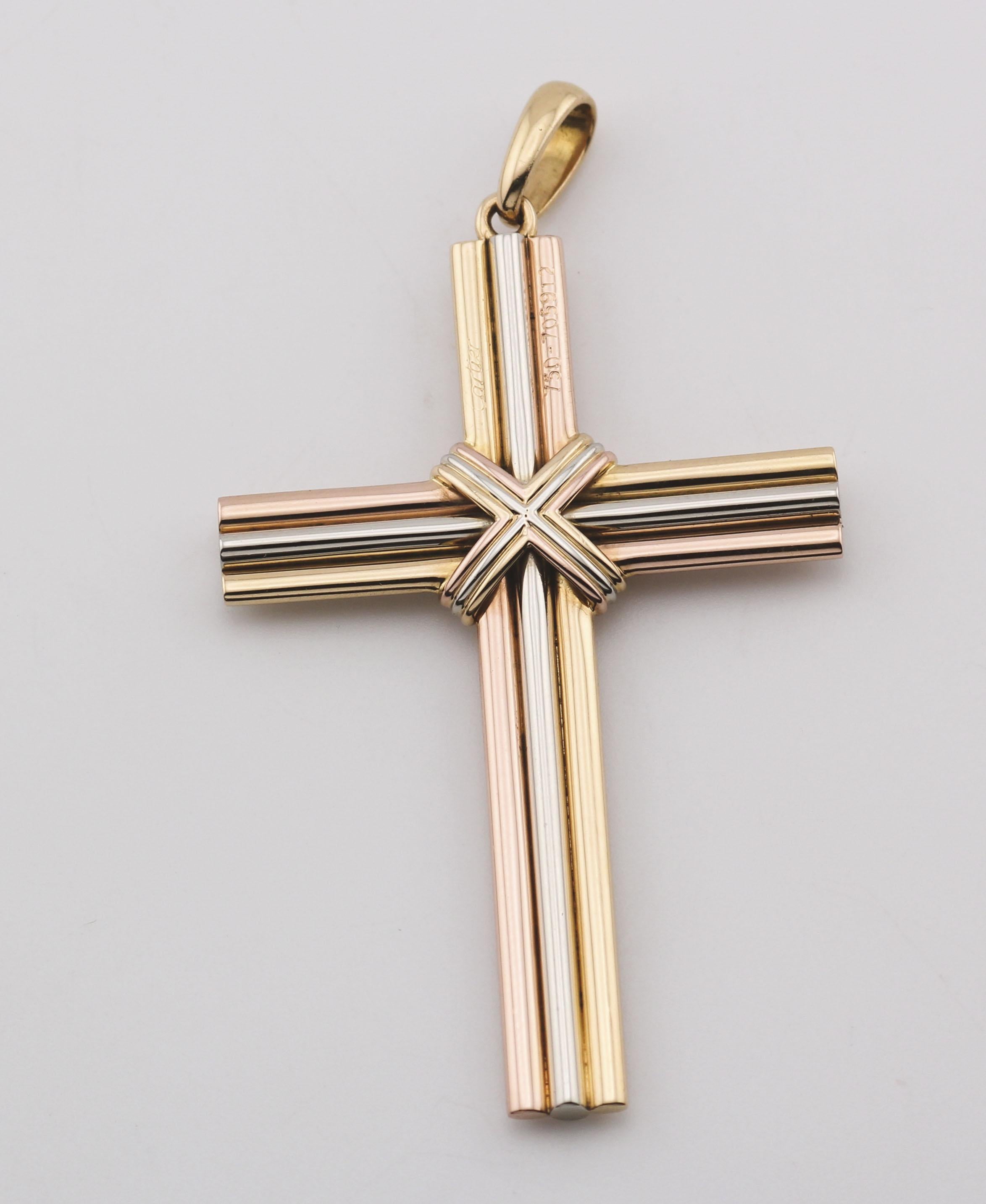A timeless symbol of unity and elegance, this Cartier Trinity Cross Charm Pendant is a striking interpretation of the Maison’s iconic design. Crafted in luxurious 18K yellow, white, and rose gold, the pendant features a bold, sculptural cross formed