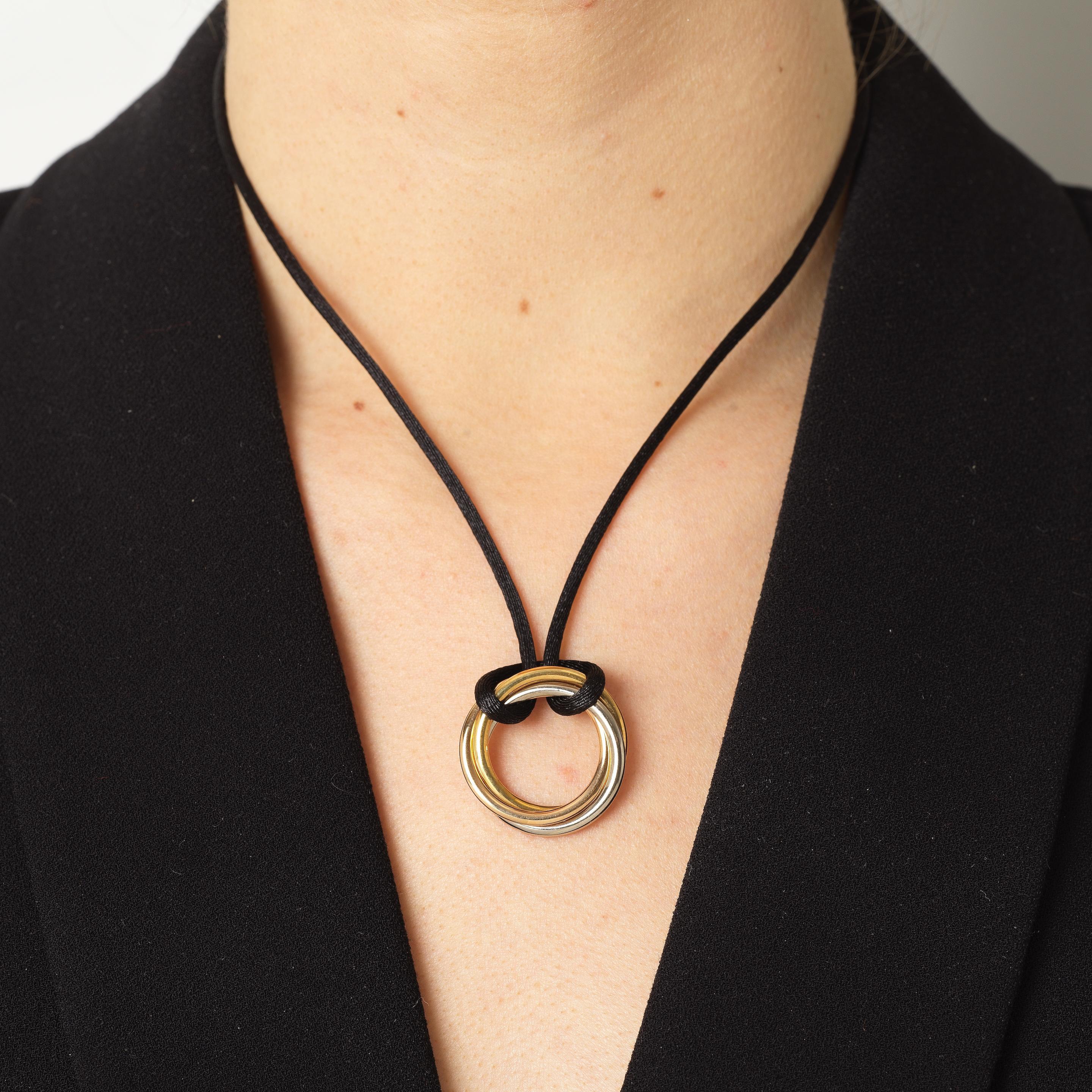 Contemporary Cartier “Trinity” 3 colour gold pendant with black silk cord  For Sale