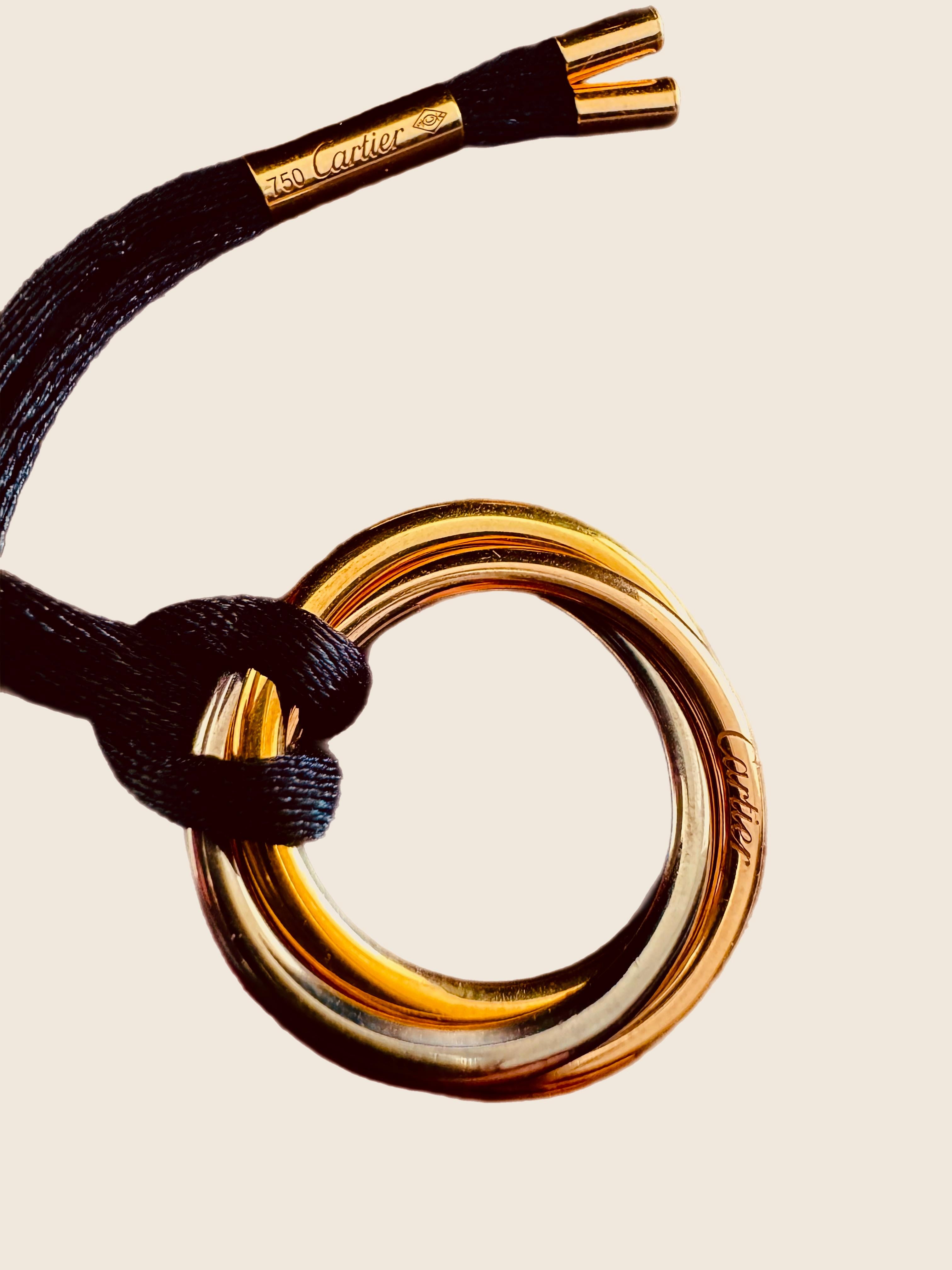 Contemporary Cartier “Trinity” 3 colour gold pendant with black silk cord  For Sale