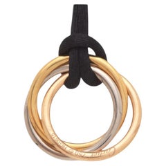 Cartier “Trinity” 3 colour gold pendant with black silk cord