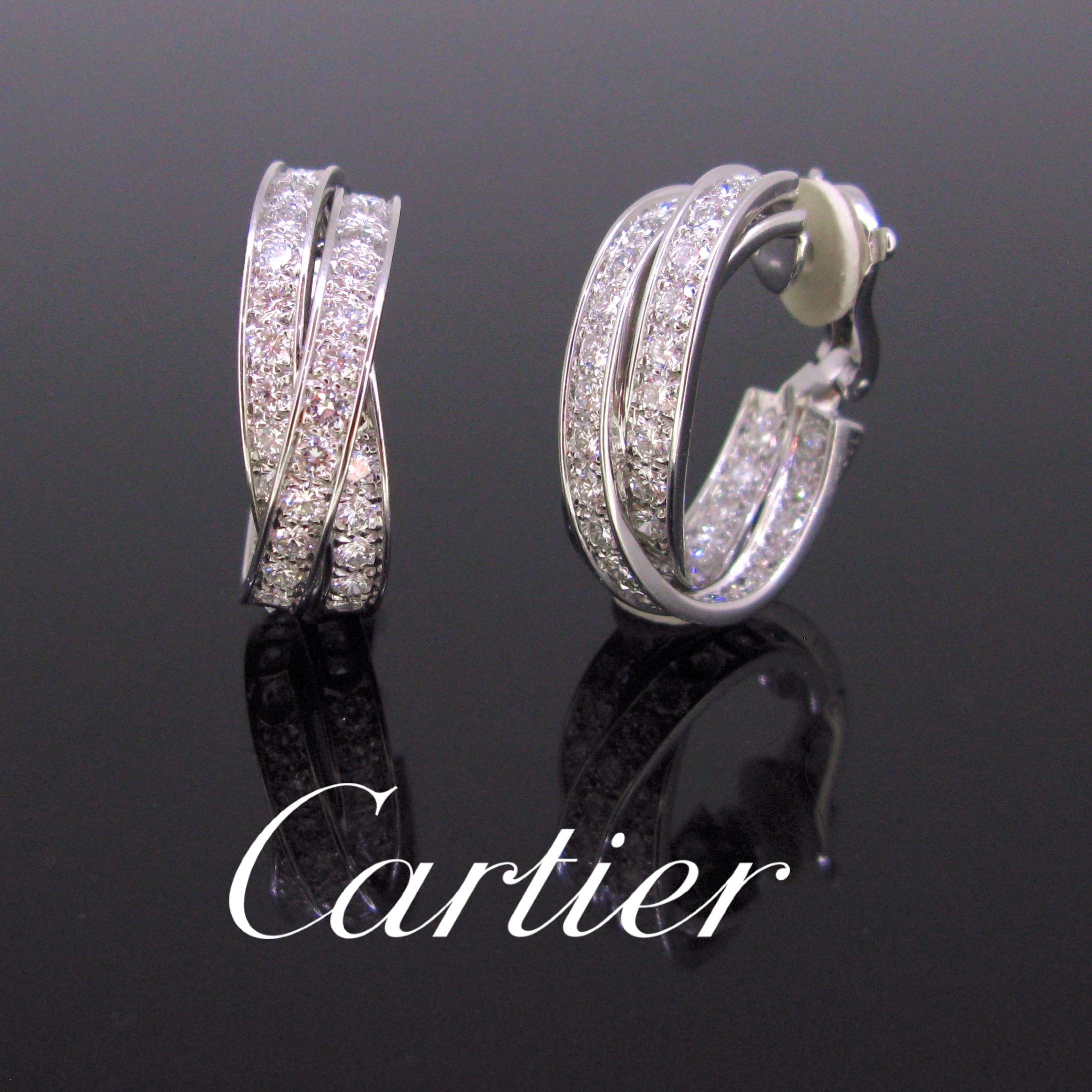 This glamorous pair of earrings comes from the Cartier’s iconic Trinity collection. They are made in 18kt white gold and set with brilliant cut diamonds. There is an approximate total carat weight of 6ct. They are signed and numbered, marked with