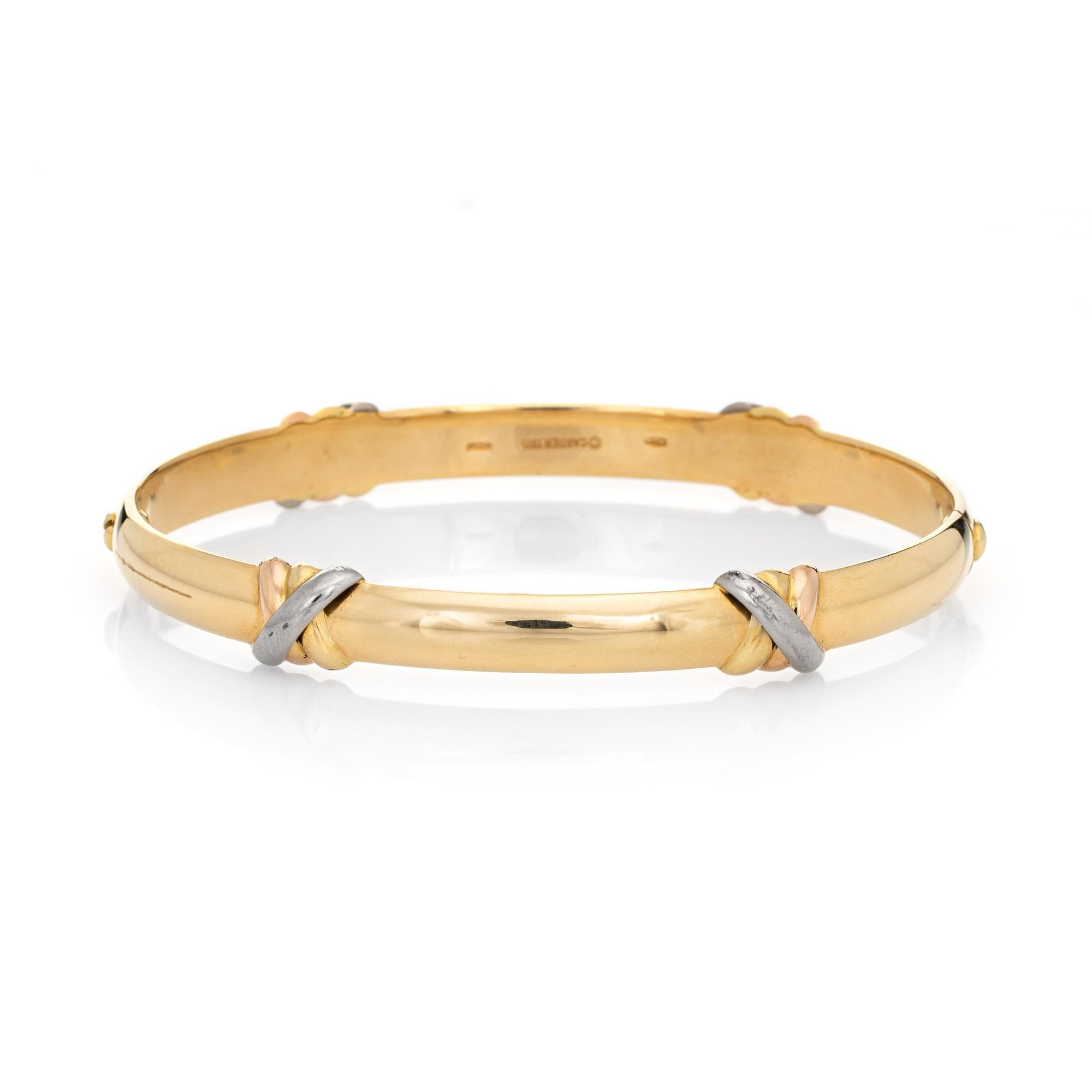 Vintage Cartier Trinity bangle bracelet crafted in 18 karat yellow gold (with a rose, white and yellow gold trinity designed stations).  

The Trinity bracelet was released in 1995 and is no longer available for sale at Cartier. A classic bracelet