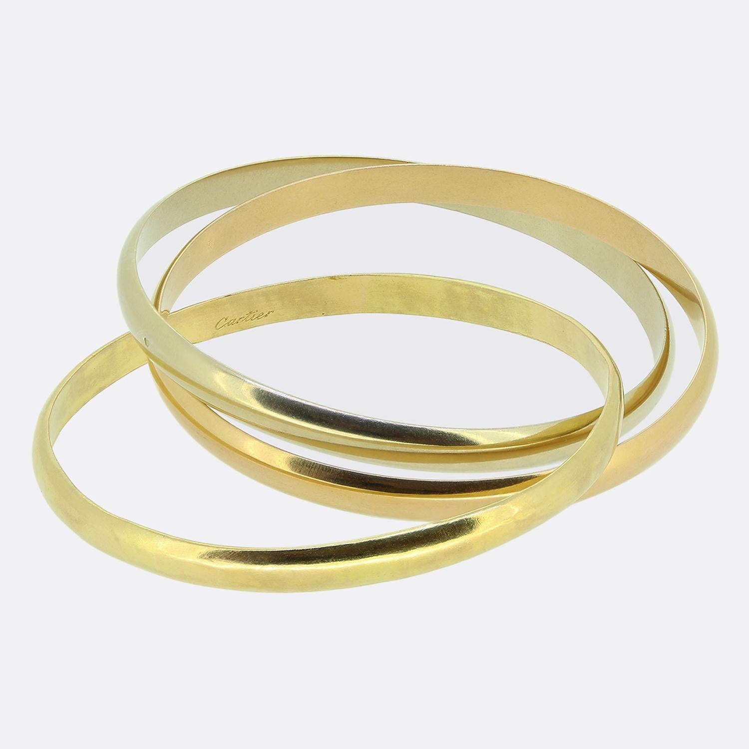 Here we have a vintage bangle from the world renowned luxury jewellery house of Cartier. This iconic piece features three interwinding bands of 18ct yellow, white and rose gold; all of which possess a smooth plain finish.

Condition: Used (Very