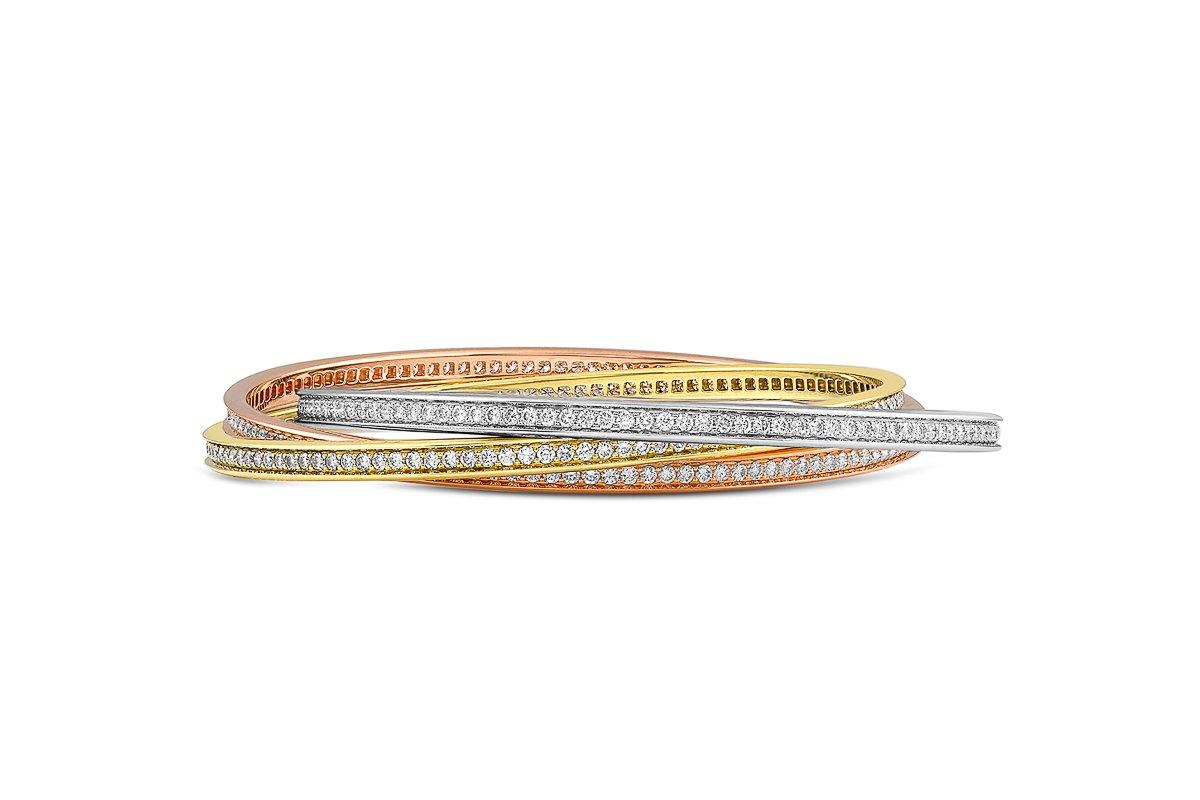 This lovely estate Cartier Trinity bangle bracelet comes in 18k rose, white and yellow gold pave set with diamonds of G color and VVS2 clarity. The diamond weight is approximately 7.08cttw in total. From the early 2000's, the bracelet size is a