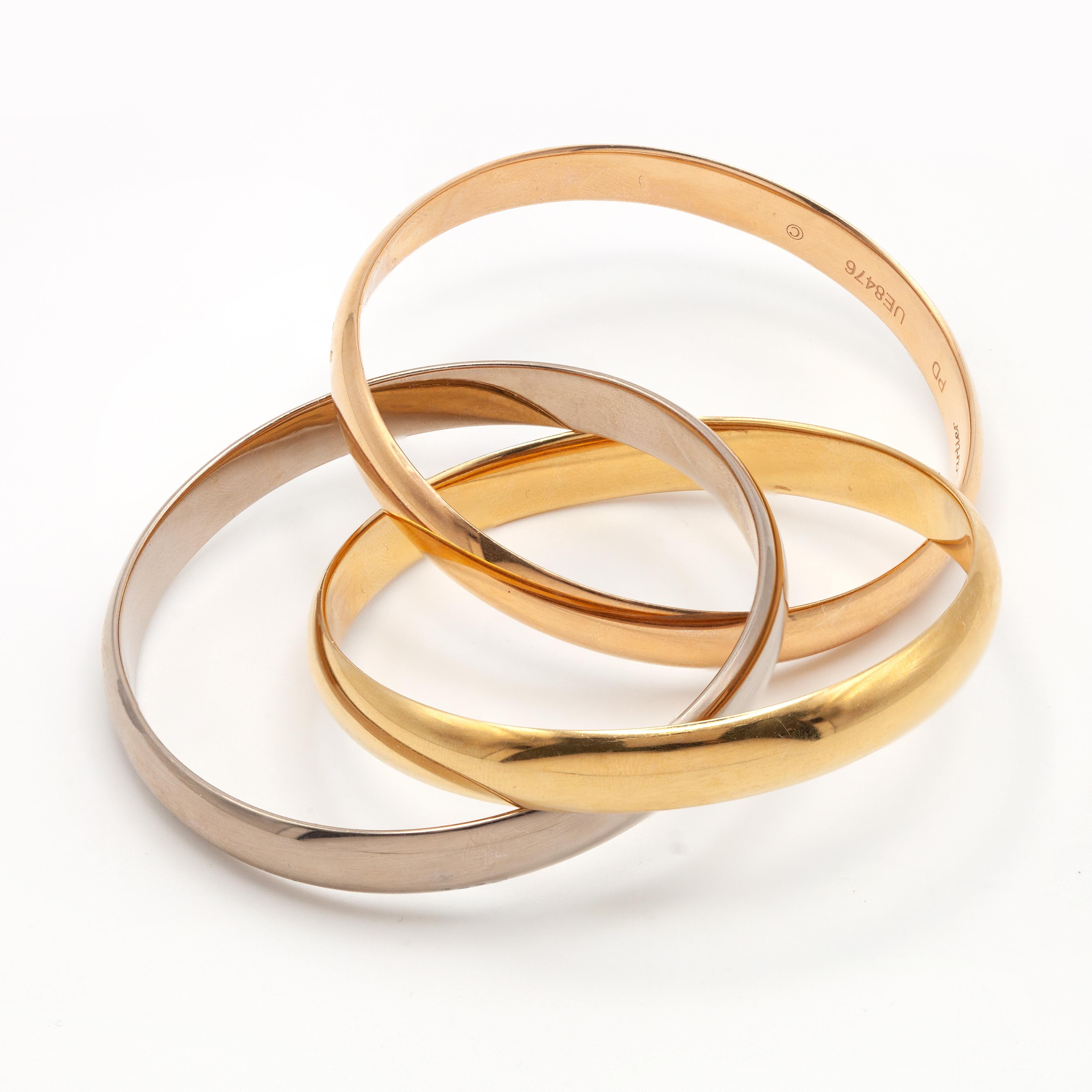 Cartier Trinity 18 Karat Tri-Color Gold Rolling Bangle Bracelet In Excellent Condition For Sale In New York, NY