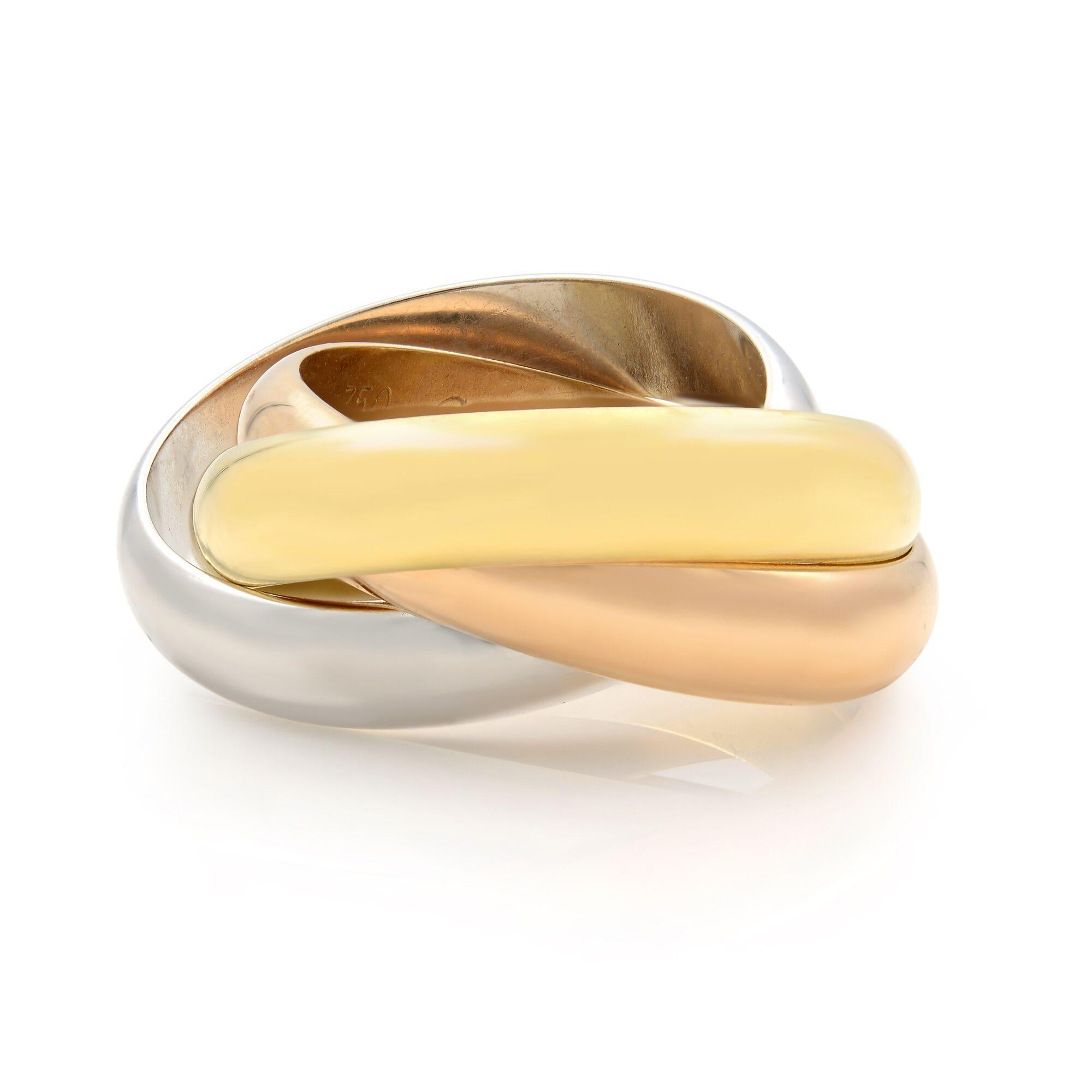Trinity ring from Cartier, crafted in 18K white gold, pink gold and yellow gold. The three interlaced bands in pink, yellow and white gold symbolize love, fidelity and friendship. This Cartier Trinity ring is pre-owned in a very good condition, old