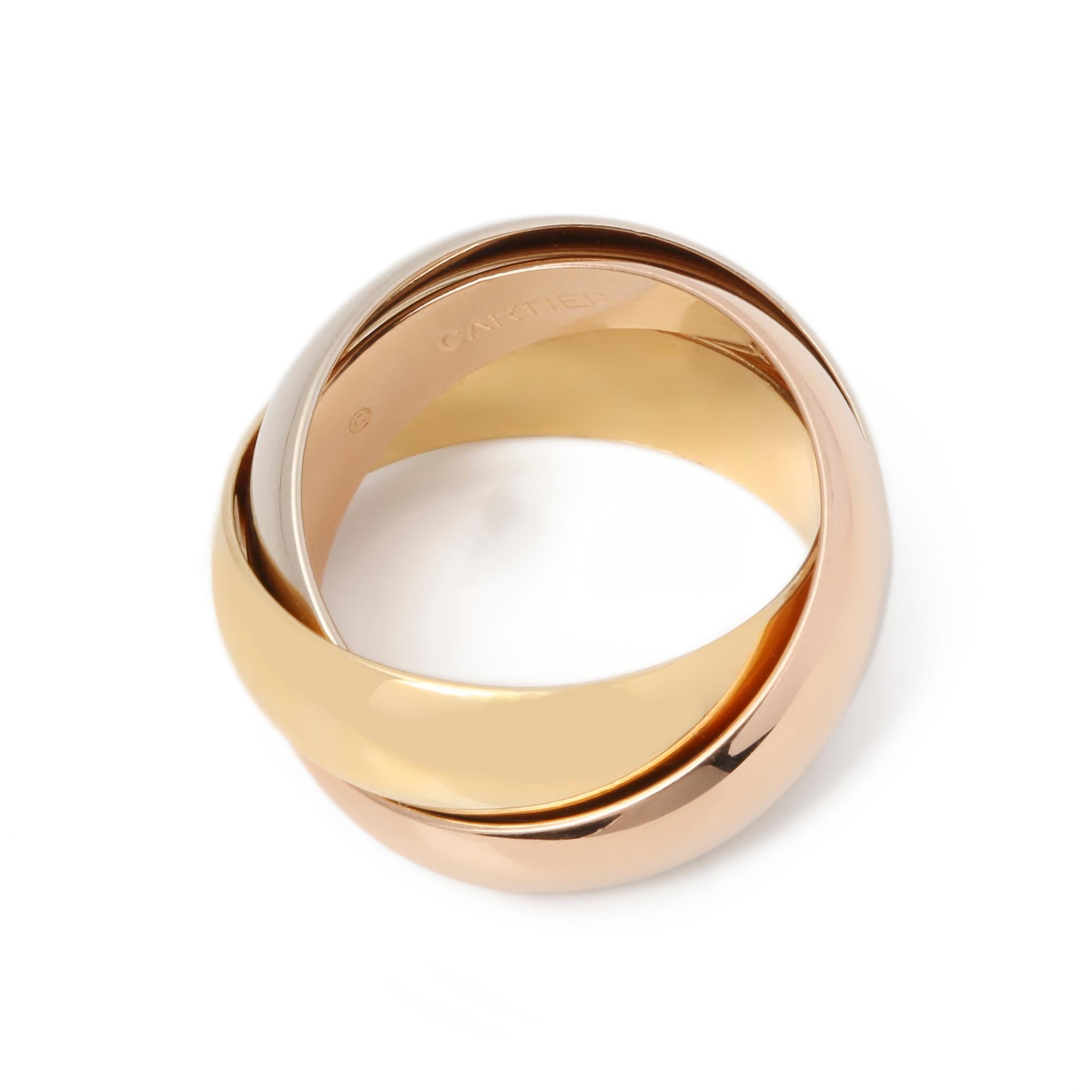 This ring by Cartier is from their Trinity collection and features 18k yellow, white and rose gold interlinking bands. UK ring size I. EU ring size 48. US ring size 4 3/4. This ring cannot be re sized. Complete with a Xupes presentation box. Our