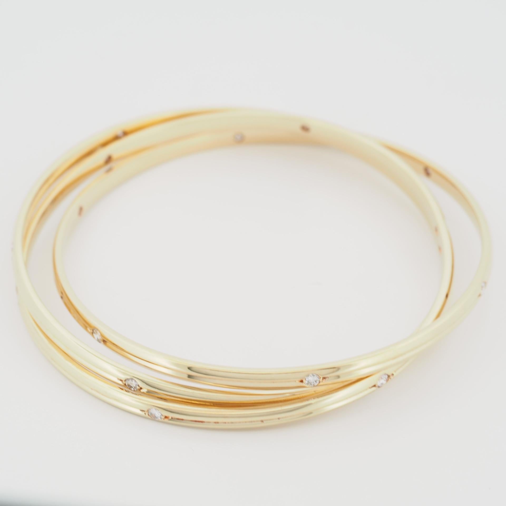 Item: Authentic Cartier Constellation Diamonds Bangle
Stone: 18 Diamonds ( approx. 1.0ct)
Metal: 18K Yellow Gold
Size: 63
Inner Diameter: 63 mm
Each Band Width: 3.4 mm 
Weight: 52.7 Grams
Condition: Used (repolished)
Retail Price: ---
Signatures: