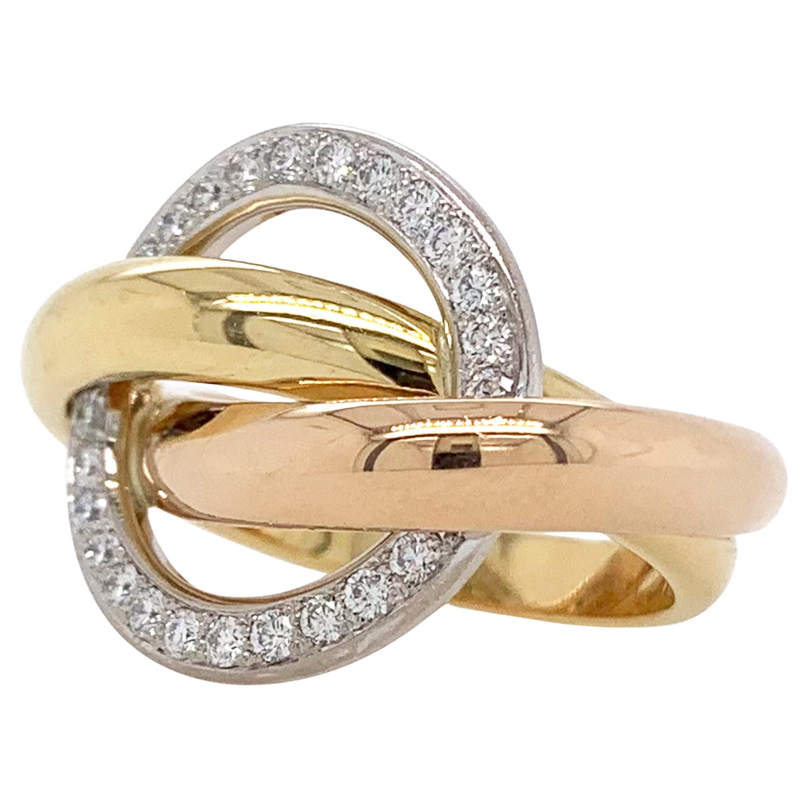 Cartier Trinity Crash diamond ring in 18k-tri gold.

This ring features a halo of 24 round brilliant cut diamonds totaling approximately 0.48 carat with E-F color and VS clarity set in 18k white gold.  The halo is supported by two intertwining bands