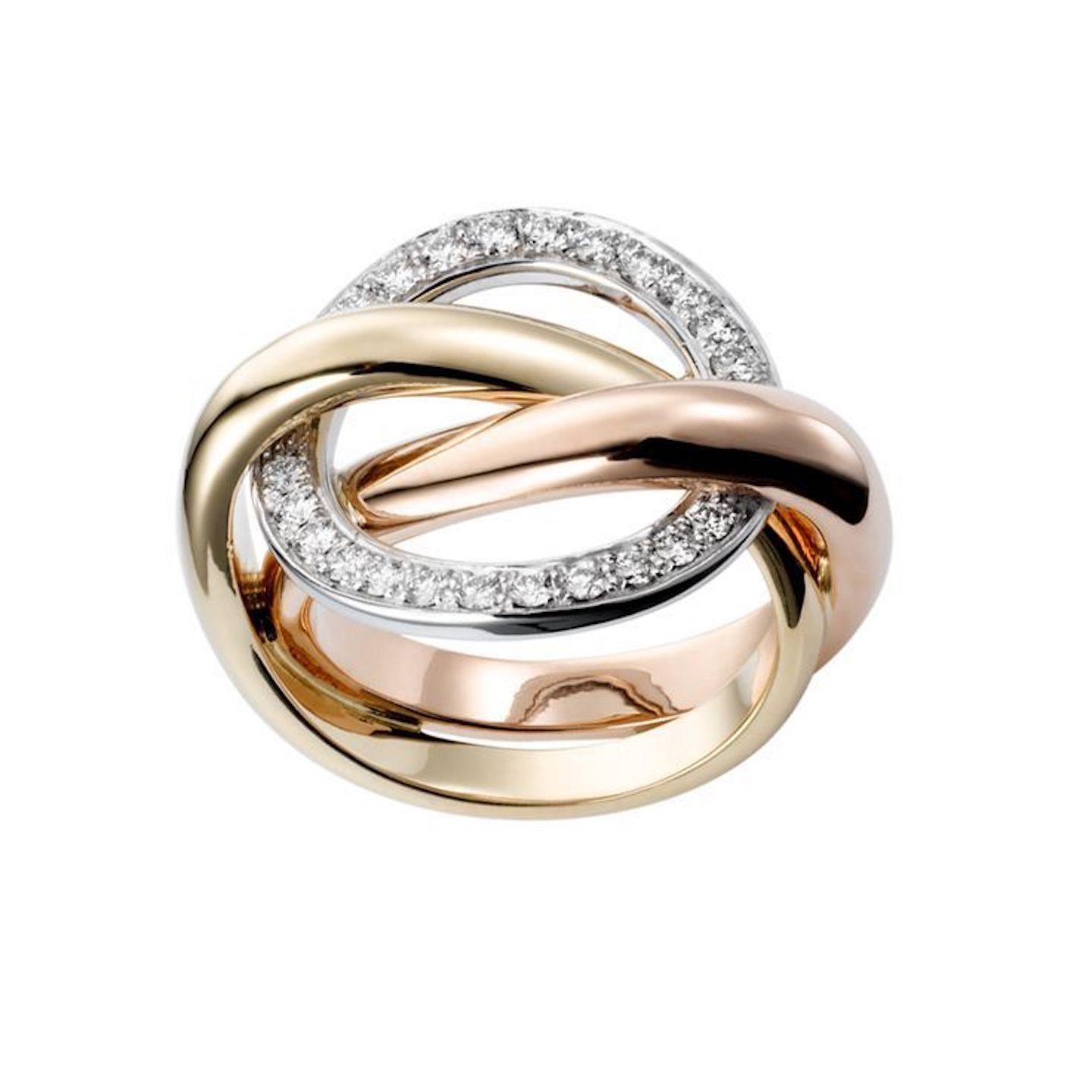 Beautiful ring crafted by famed jewelry house Cartier. This design is known as the Cartier Trinity 'Crash' ring and is comprised of interlocking tri-color 18 karat gold bands. The fixed white gold band is set with round brilliant cut diamonds