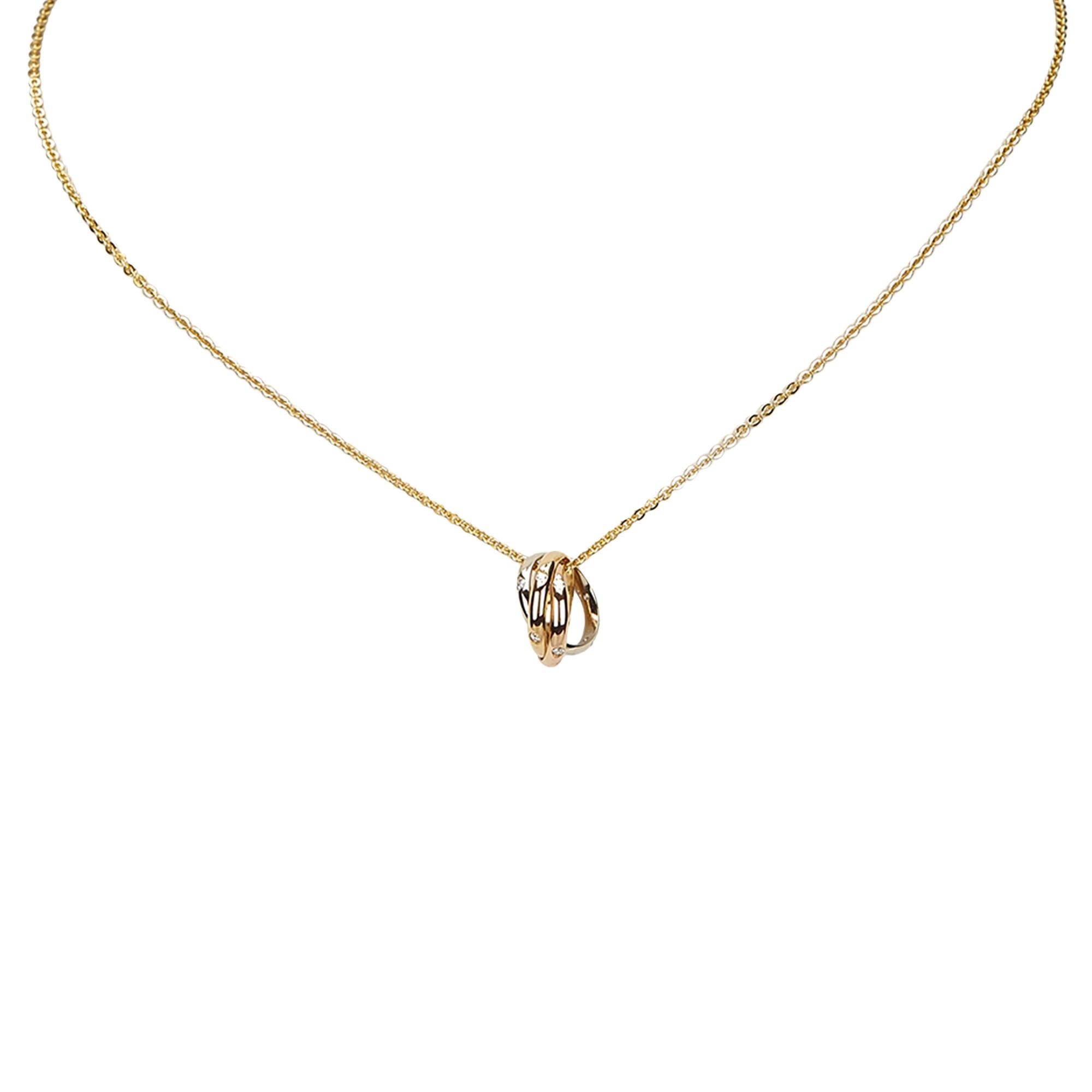 Cartier Trinity de 18k Tri-color Gold 15 Diamond Pendant Necklace.  Triple ring pendant set with 15 white diamonds in white gold, rose gold, and yellow gold.  Yellow gold chain necklace with lobster clasp. Kate Middleton is shown wearing the same