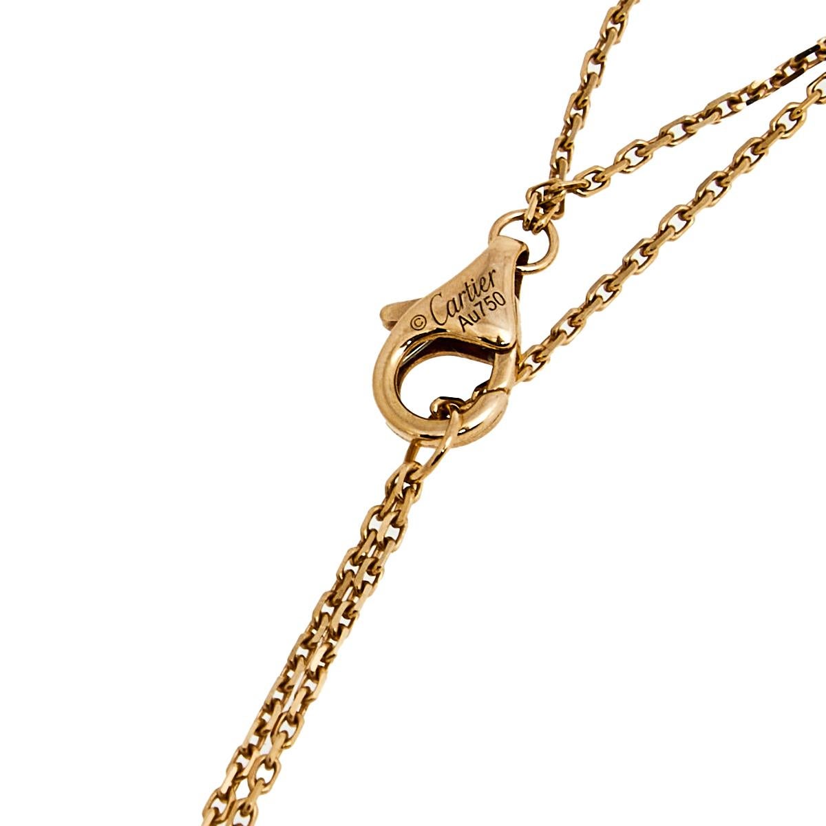 This minimalist necklace comes from Cartier's Trinity collection that symbolizes elegance and style. The 18k gold creation features dual chains that carry three-tone 18k gold rings—a signature of the collection symbolizing love, fidelity, and