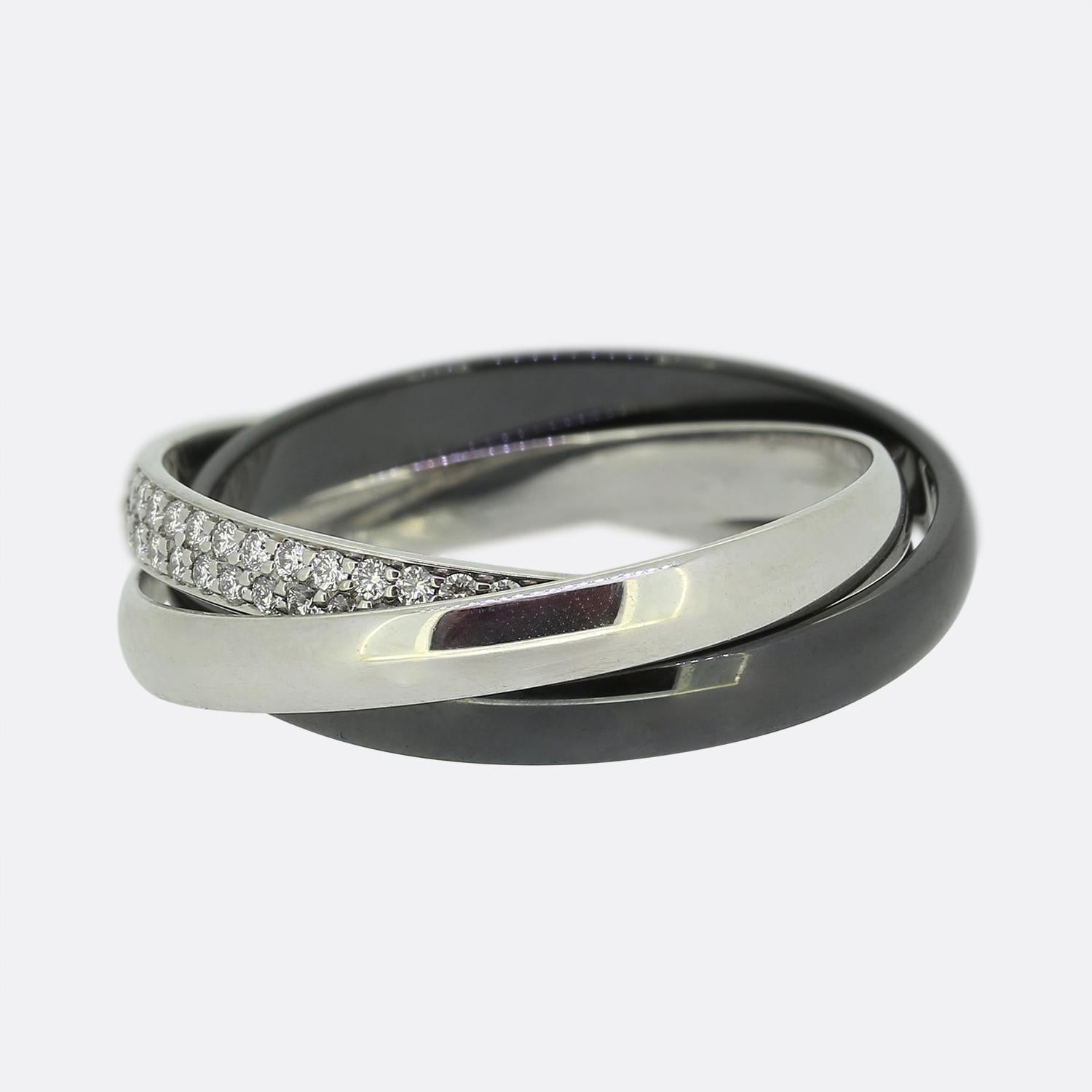 Here we have an platinum and 18ct white gold diamond trinity ring from the world renowned luxury jewellery house of Cartier. This ring features three interwinding bands. One 18ct white gold, one platinum and one in darkened ceramic; the white gold