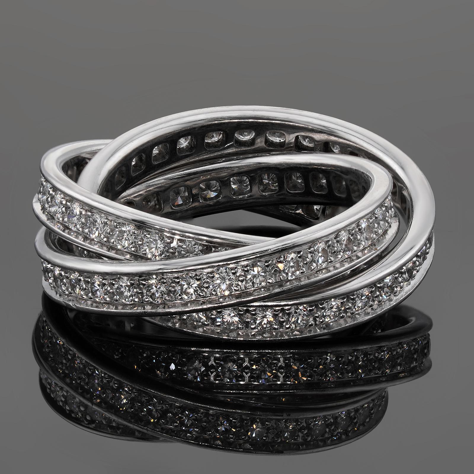 This iconic ring from Trinity de Cartier collection features 3 interconnected bands in crafted 18k white gold and pave-set with with brilliant-cut round D-F VVS1-VVS2 diamonds. Made in France circa 1990s. Measurements: 0.27