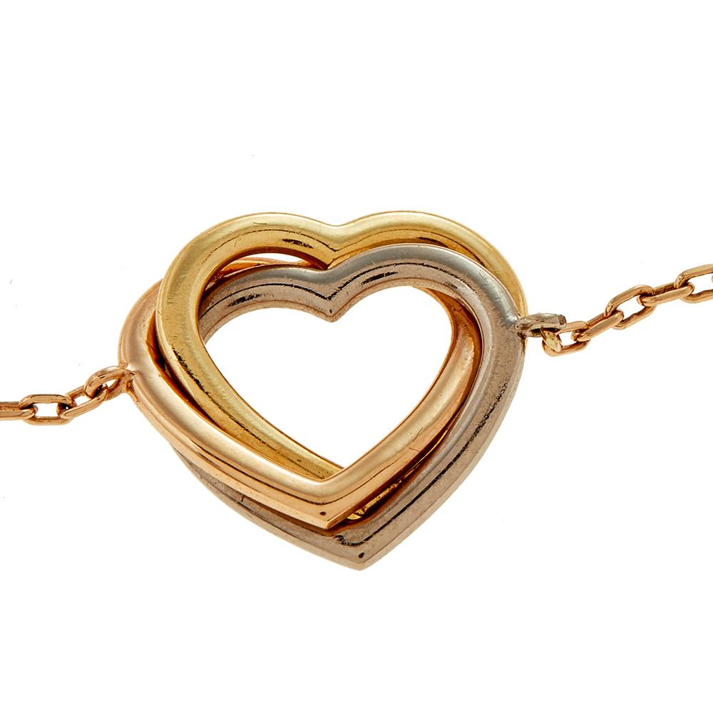 This exquisite Cartier Trinity bracelet is beautifully crafted in a flawless design. Featuring three intertwined hearts in pink, yellow, and white, this classic piece is intrinsically feminine and pretty. Designed in 18k gold, this stunning bracelet