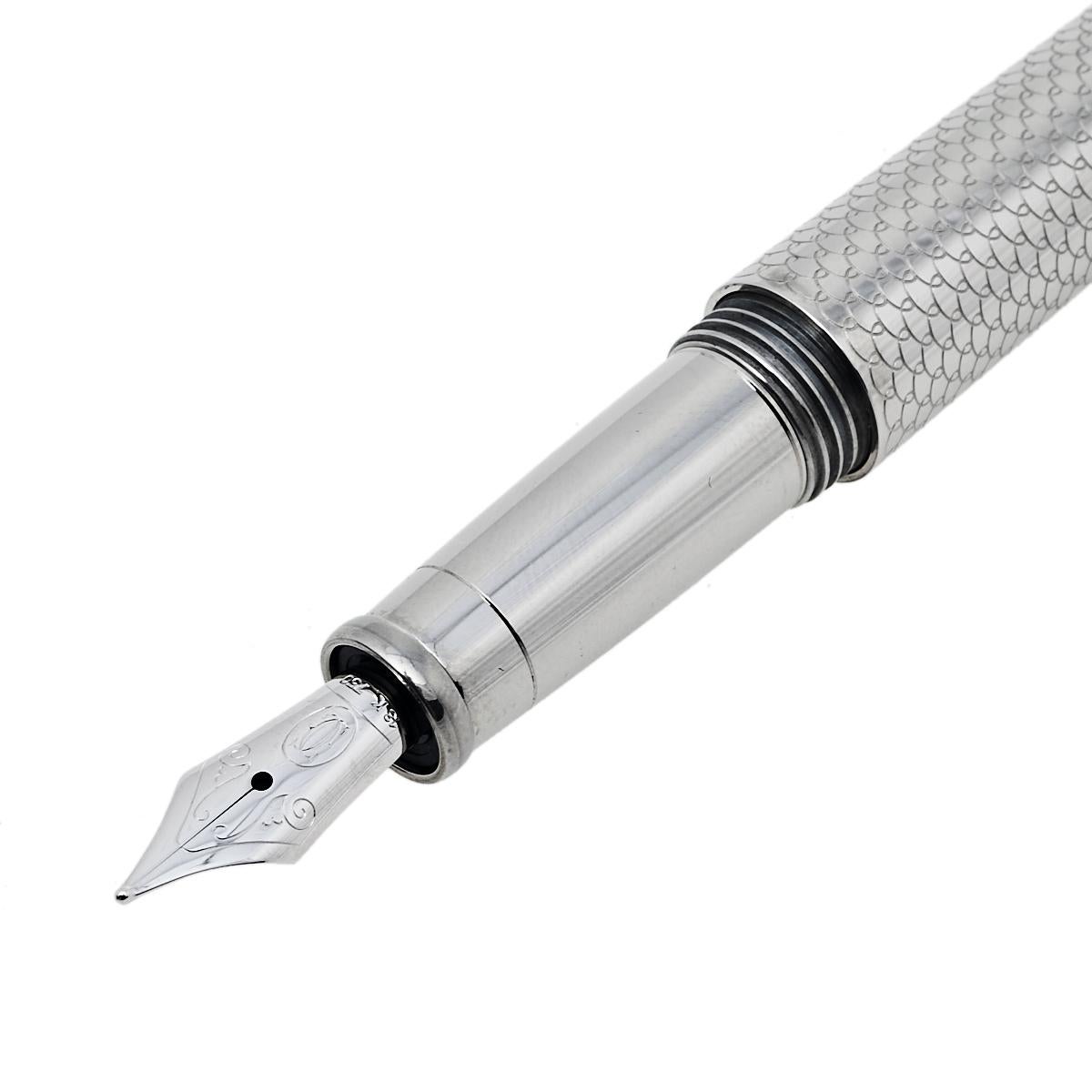 Let your dream of owning a fine pen come alive with this masterpiece from Cartier! It is a part of the brand's Trinity De Cartier collection and comes crafted from palladium hardware and adorned with a 'Resille' decor pattern that looks