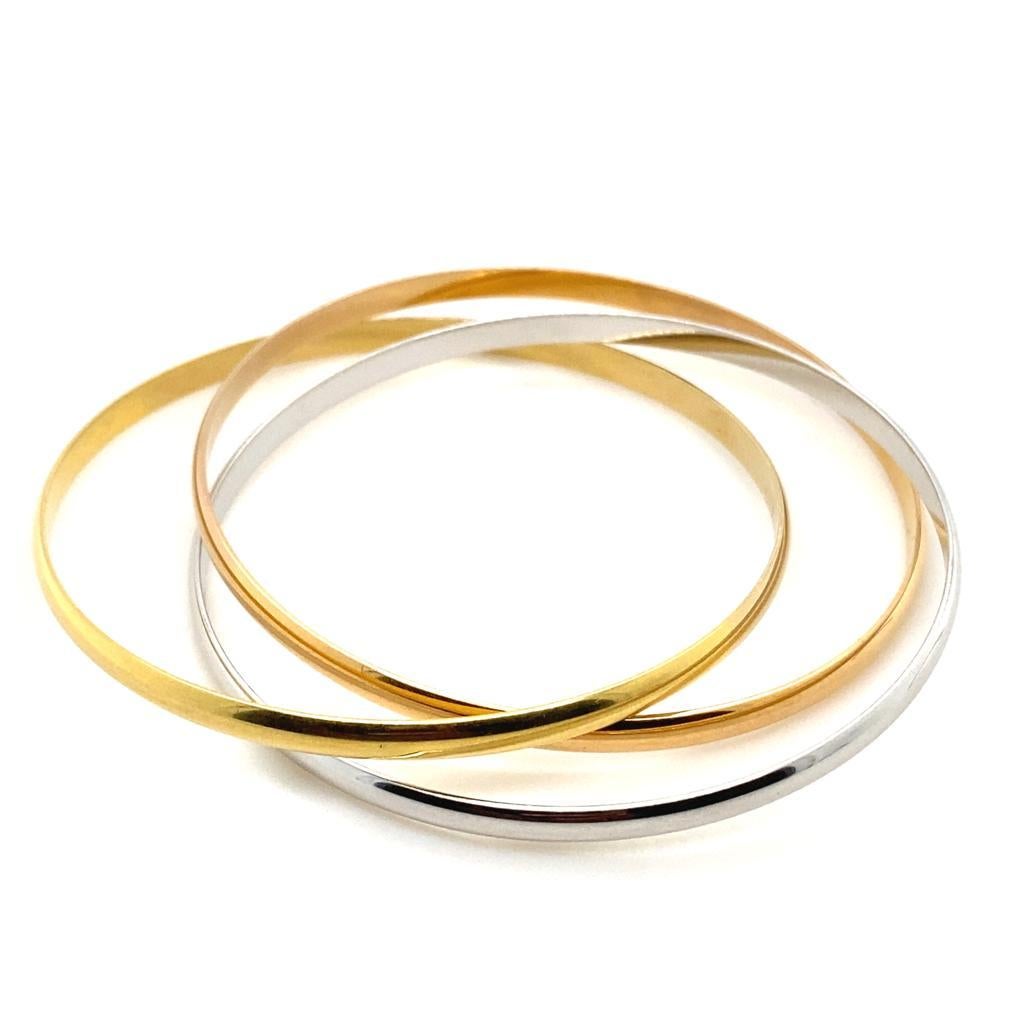 A Cartier ‘Trinity de Cartier’ three bangle bracelet.

This classic, vintage piece is composed of three interlocking bangles, one each in yellow gold, white gold and rose gold. 
Louis Cartier created the trinity ring in 1924 and each colour is