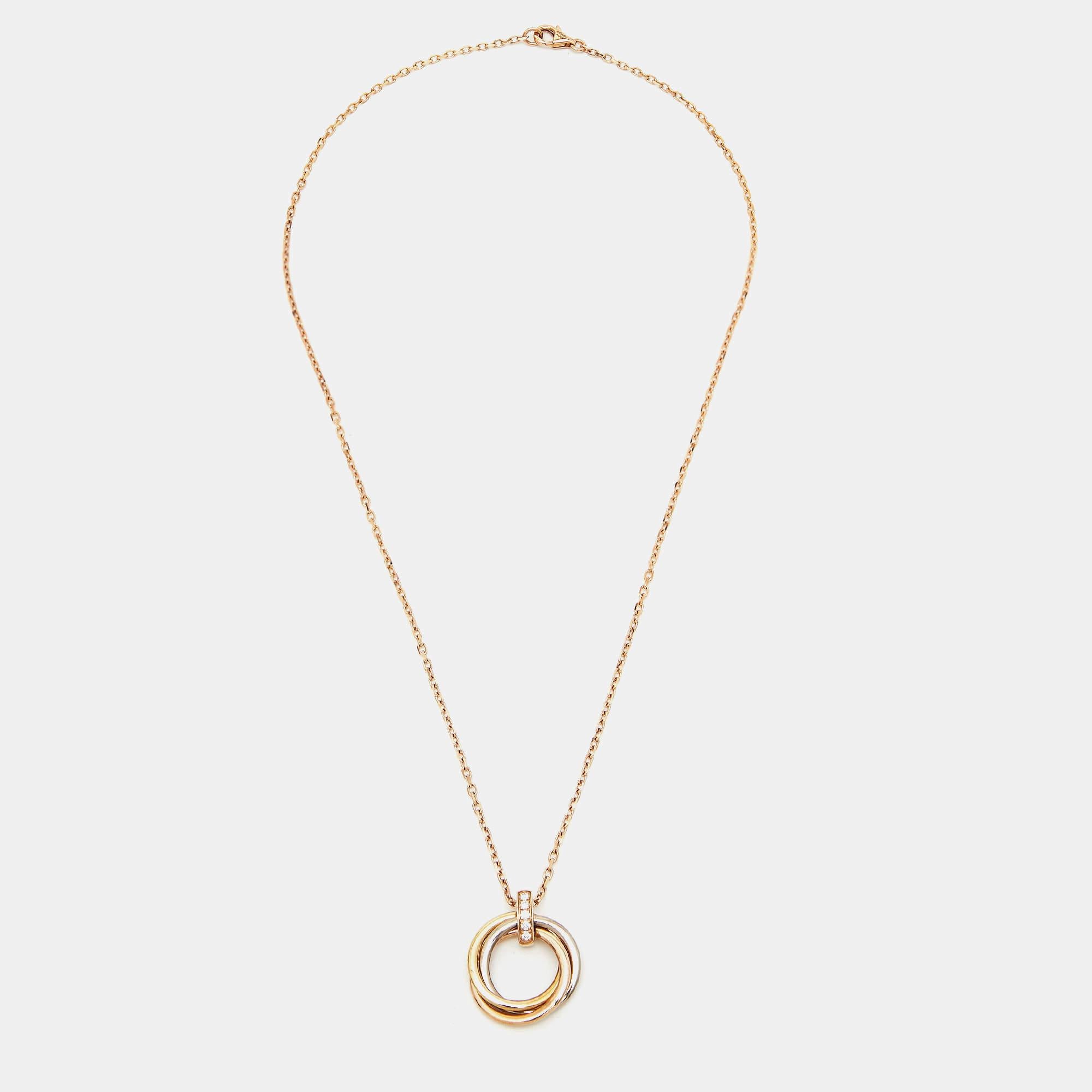 This lovely pendant necklace from Cartier is sure to become one of your favorite accessories It comes crafted from 18k gold and the pendant has the signature Trinity rings in three tone gold.