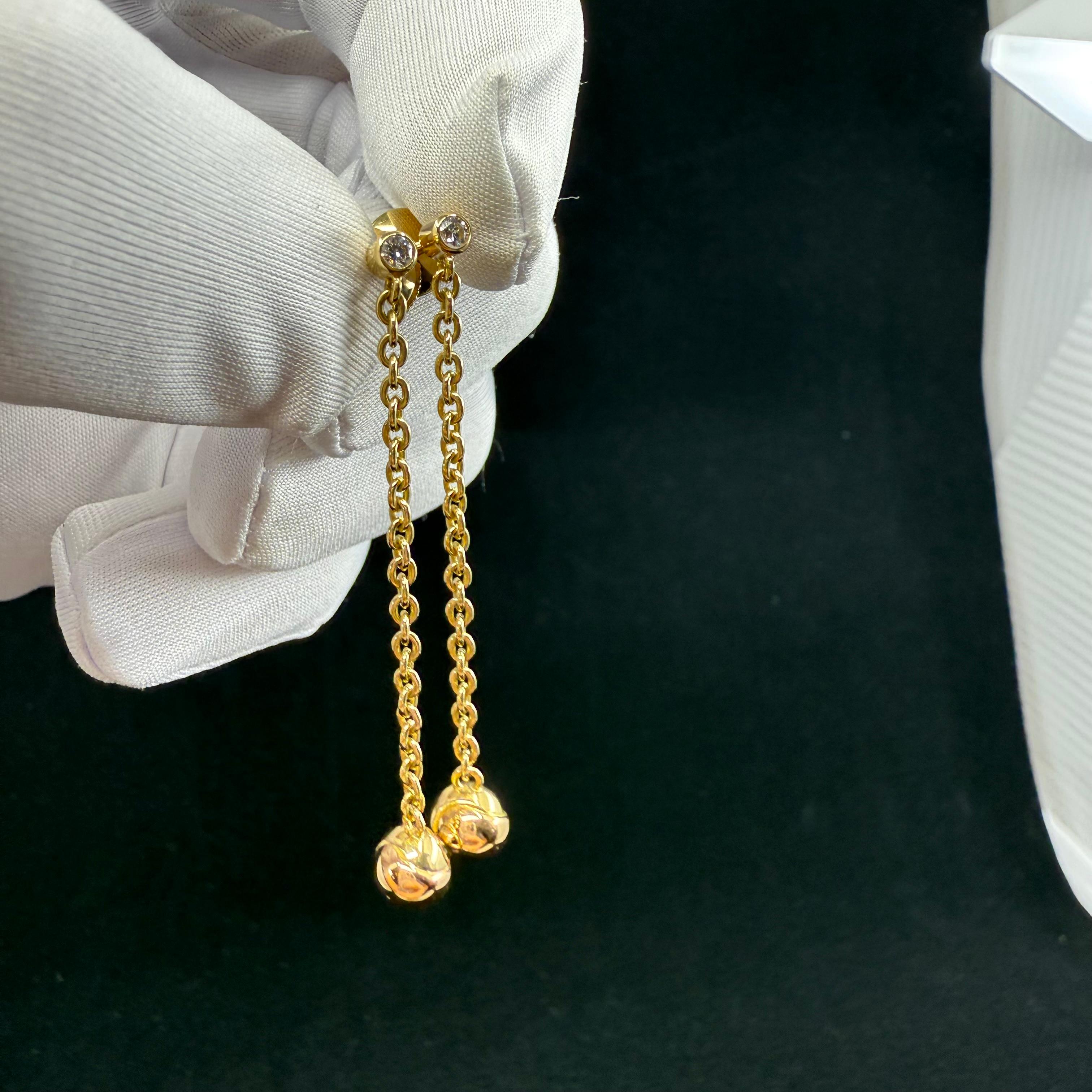 Cartier Trinity 18 karat yellow gold diamond drop earrings.
Top is Two Round Diamonds of D-E Color and VVS clarity .10 CTS.
18 karat link chain 2 inches drop with a trinity three color gold endless sphere. Comes with box no papers. Hallmarked and