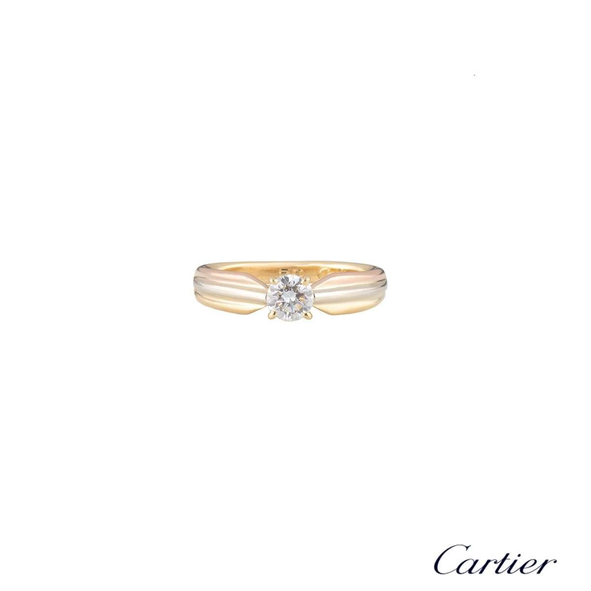 An 18k tri-colour gold diamond ring from the Trinity de Cartier collection. The ring is set to the centre with a 0.34ct round brilliant cut diamond, E-F colour and VVS2 in clarity. The diamond is set within a classic 4 claw setting with the band