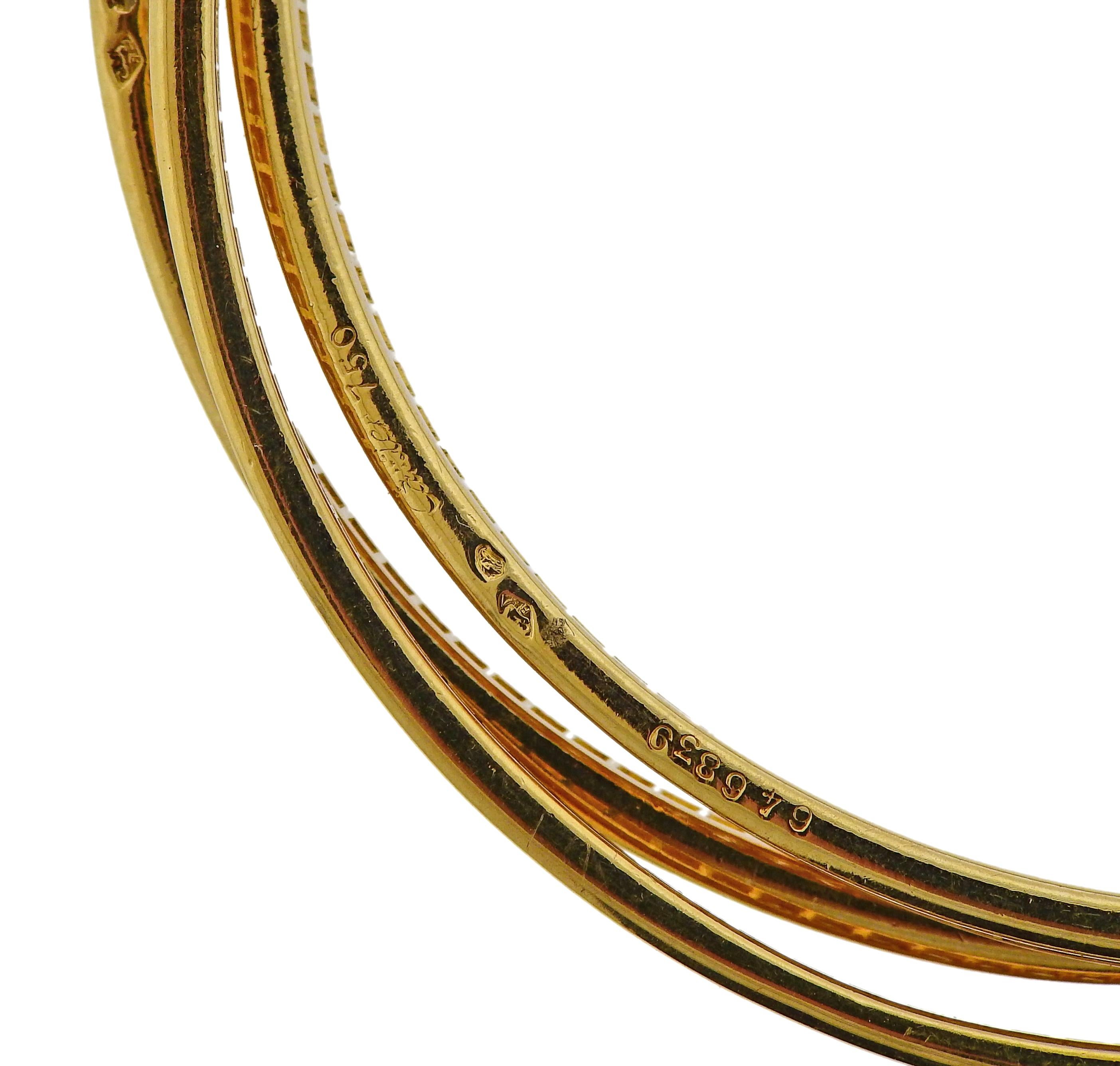 Bracciale Trinity rolling tri in oro giallo 18 carati, con circa 8,85 carati di diamanti incastonati, realizzato da Cartier. Il bracciale si adatta a un polso di circa 7 pollici ed è largo 11 mm quando è indossato. Marcato 046839, 750, Cartier,
