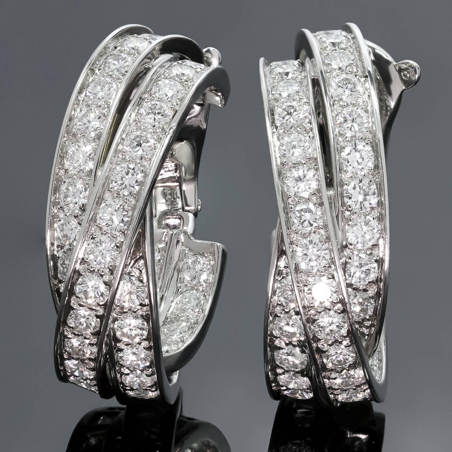 These fabulous in inside-out oval wrap earrings from Cartier's iconic Trinity collection are crafted 18k white gold and set with sparkling brilliant-cut diamonds of an estimated 5.50 carats. This is the large model of these flattering and rare