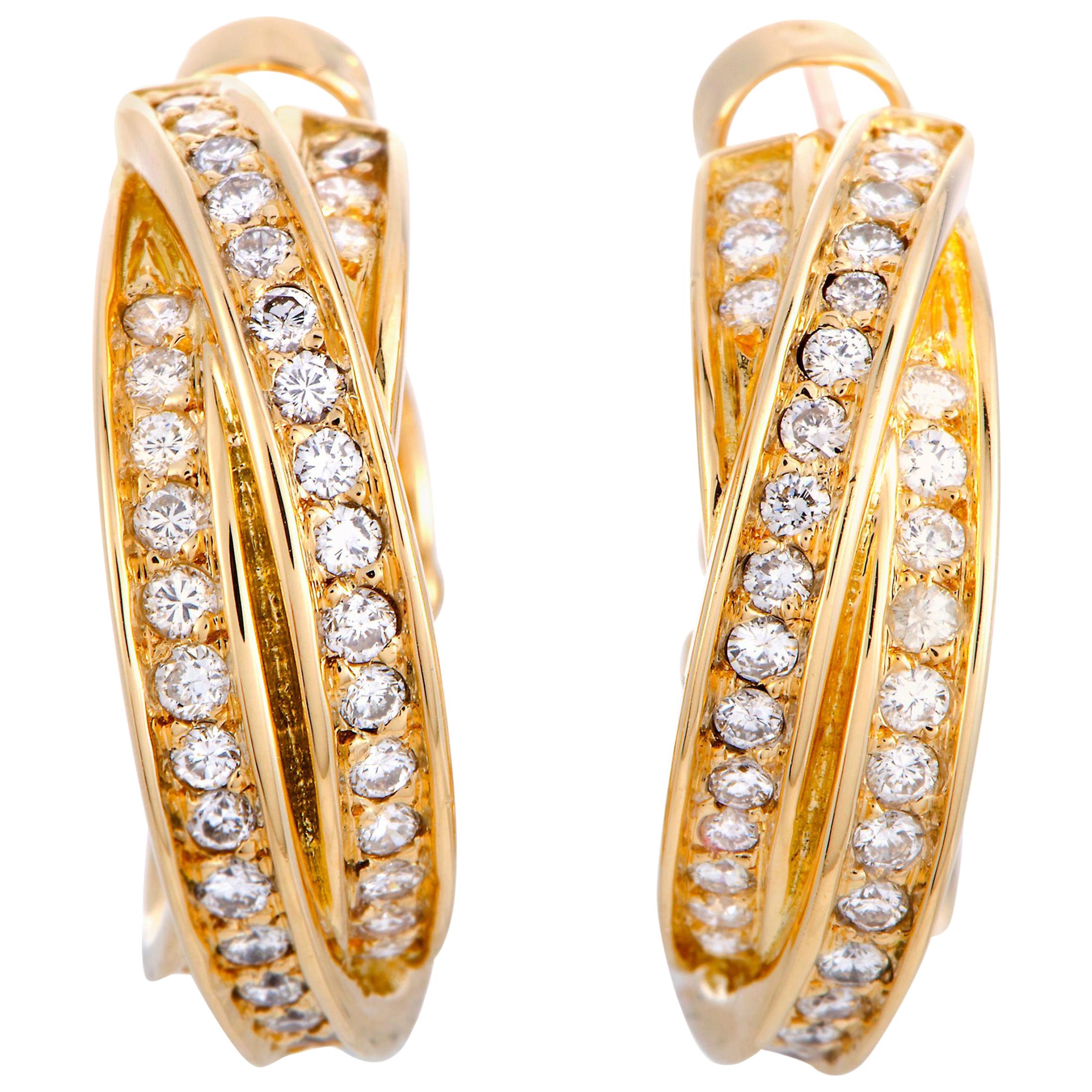 The Cartier “Trinity” earrings are made out of 18K yellow gold and diamonds and each of the two earrings weighs 7.35 grams, measuring 0.81” in length and 0.25” in width.

This pair of earrings is offered in estate condition and includes the