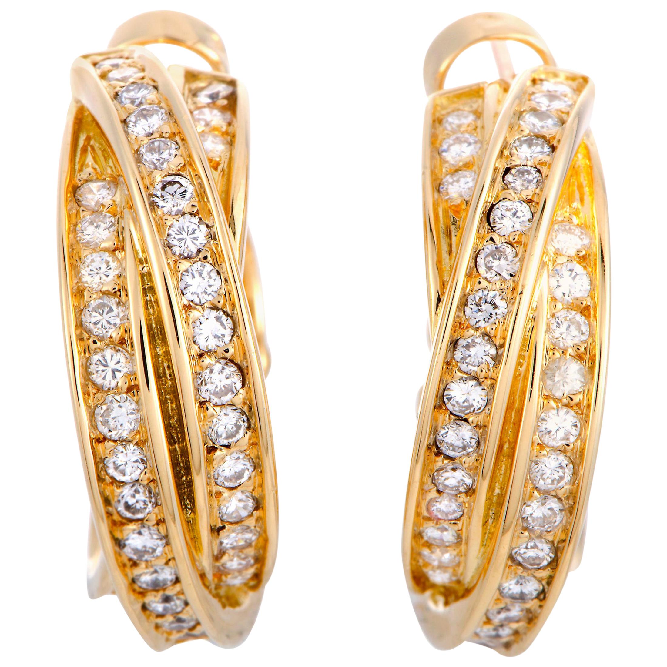 The Cartier “Trinity” earrings are made out of 18K yellow gold and diamonds and each of the two earrings weighs 7.35 grams, measuring 0.81” in length and 0.25” in width.

This pair of earrings is offered in estate condition and includes the