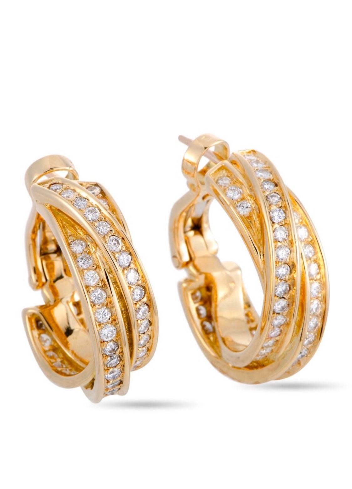 The Cartier “Trinity” earrings are made out of 18K yellow gold and diamonds and each of the two earrings weighs 7.35 grams, measuring 0.81” in length and 0.25” in width.

