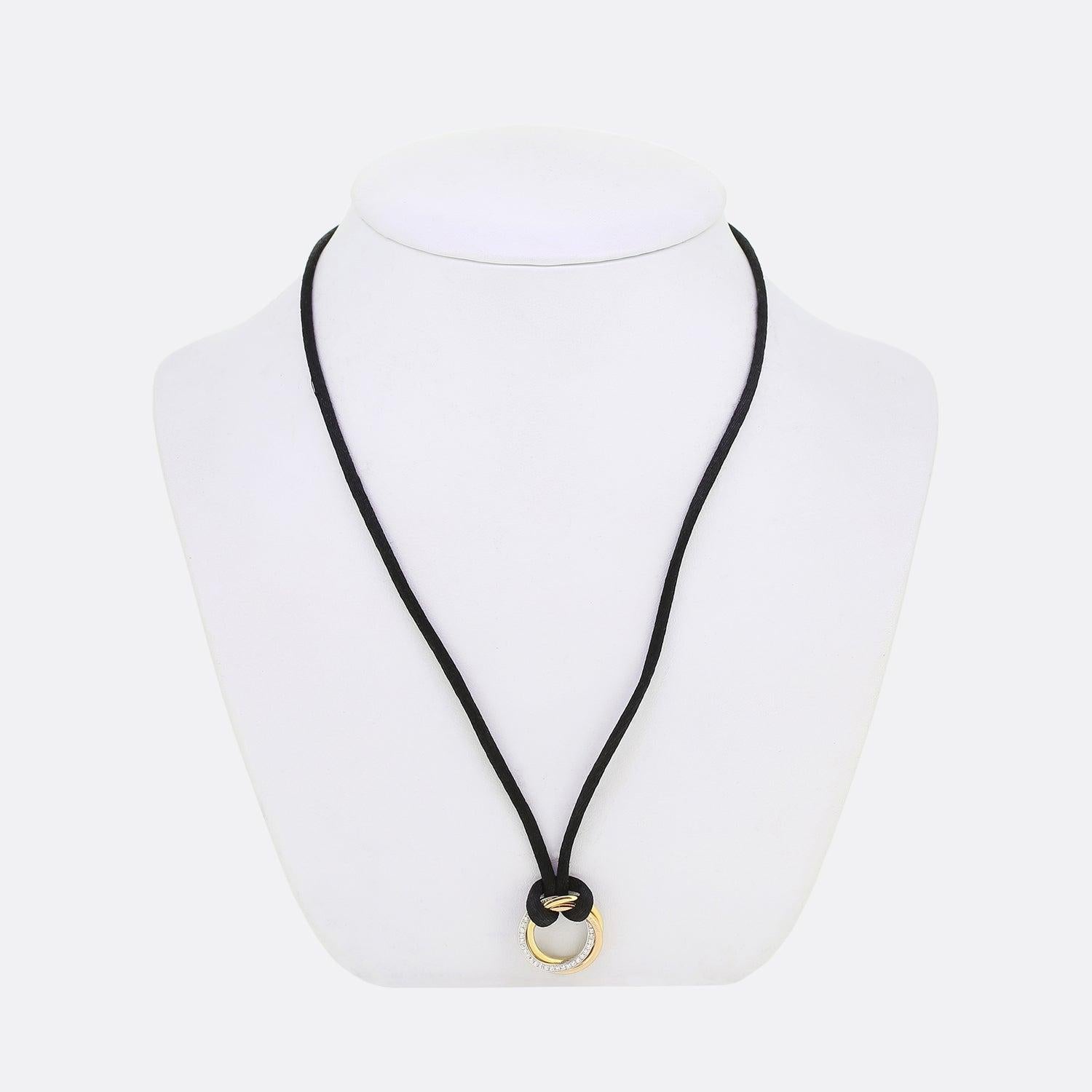 Ecco un pezzo iconico della famosa casa di gioielli di lusso Cartier. La collana presenta tripli anelli intrecciati in oro giallo, bianco e rosa. L'anello in oro bianco è impreziosito da un pavé di diamanti rotondi a taglio brillante che aggiungono