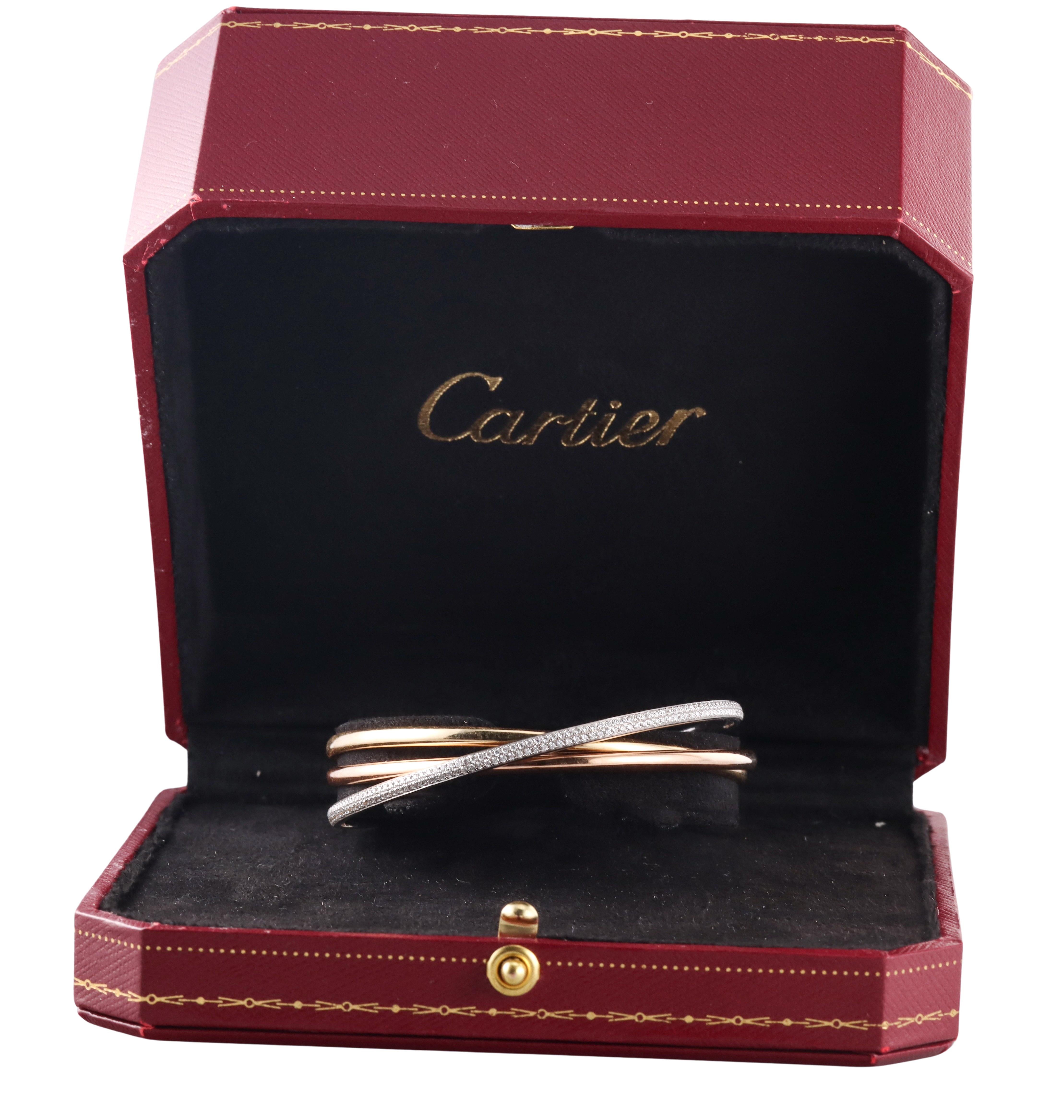 Signature Trinity bracelet by Cartier, set in 18k rose, white and yellow gold, with a full circle of pave set diamonds - 1.56ctw G/VS. The bracelet measures 2.25