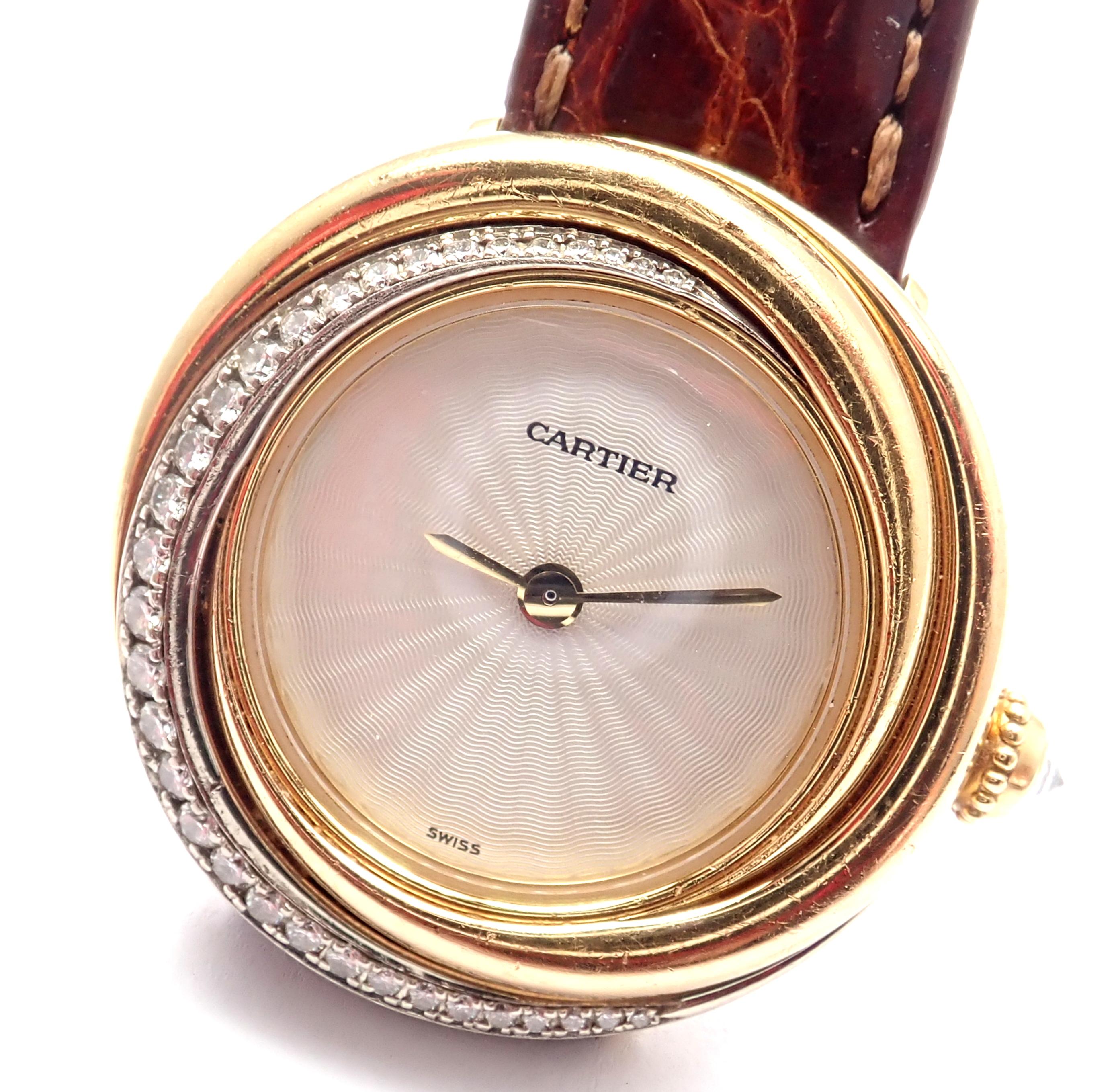 18k Tri-Color Gold Diamond Trinity Wristwatch by Cartier. 
With Round brilliant cut diamonds VVS1 clarity, E color.
Style Name: Trinity
Reference Number: 2357
Case Material: 18k Tri-Color Gold with Diamonds
Dial Color: Silvery-white guilloche