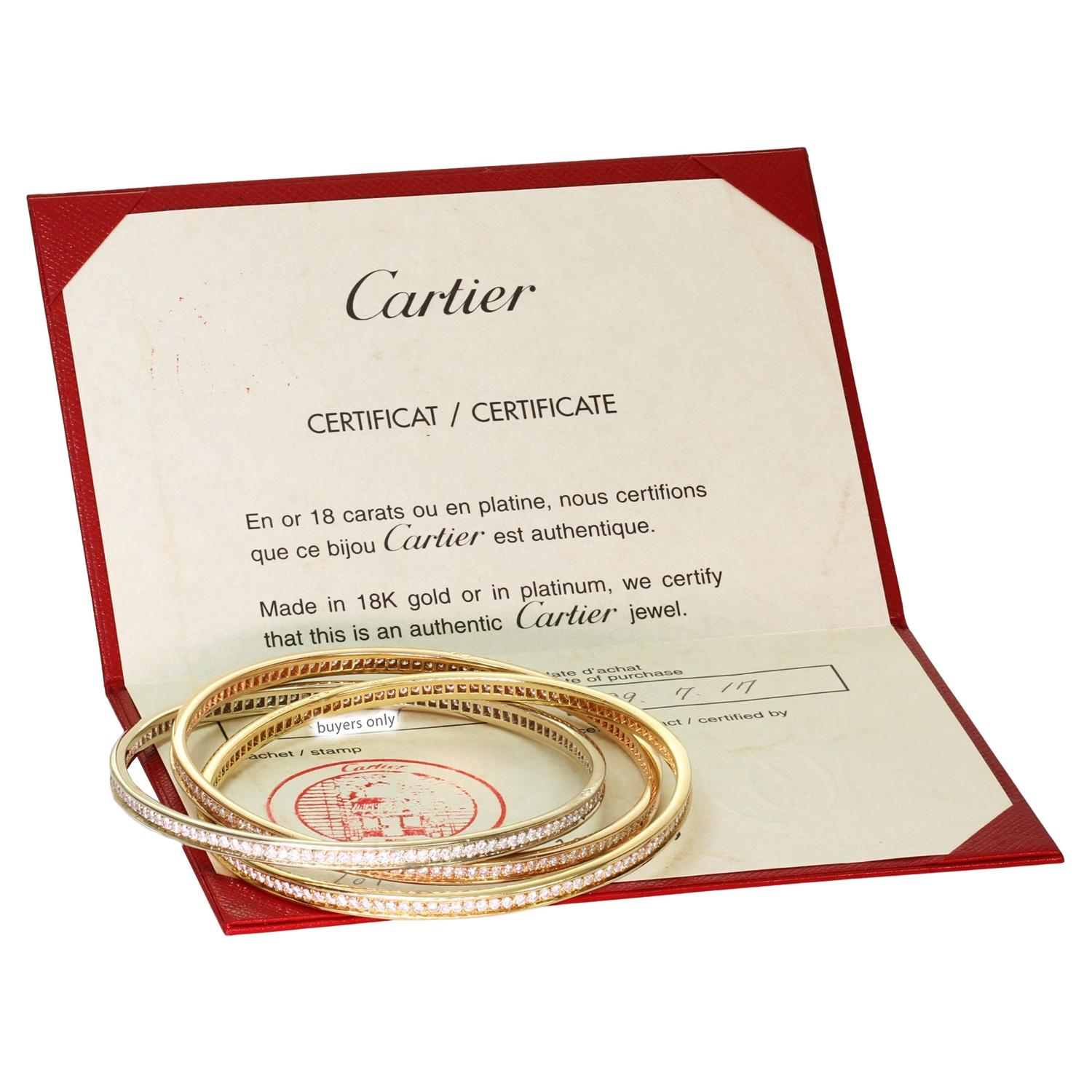 This gorgeous Cartier bracelet from the classic Trinity collection features 3 interconnected bangles crafted in 18k yellow, white, and rose gold. All three bangles are set with with E-F VVS1-VVS2 brilliant-cut round diamonds weighing an estimated